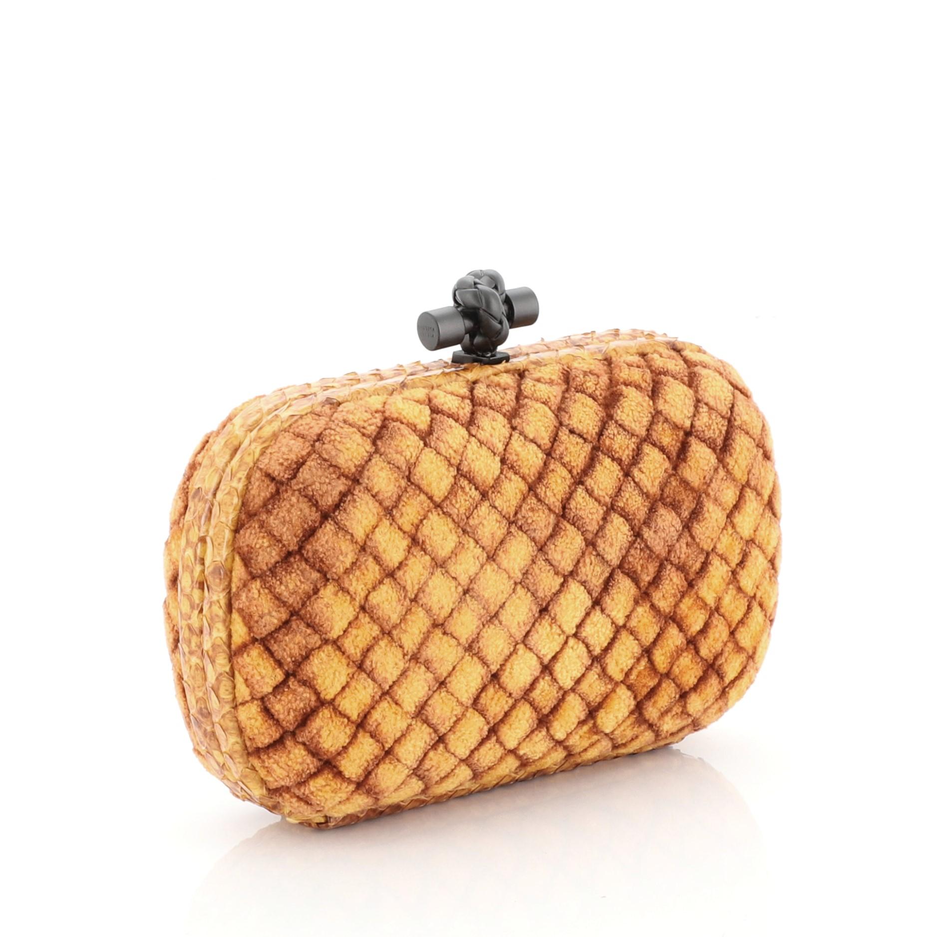 This Bottega Veneta Box Knot Clutch Velvet with Snakeskin Small, crafted from orange velvet, features snakeskin frame trims and matte gunmetal-tone hardware. Its top knot clasp closure opens to an orange leather interior  

Estimated Retail Price: