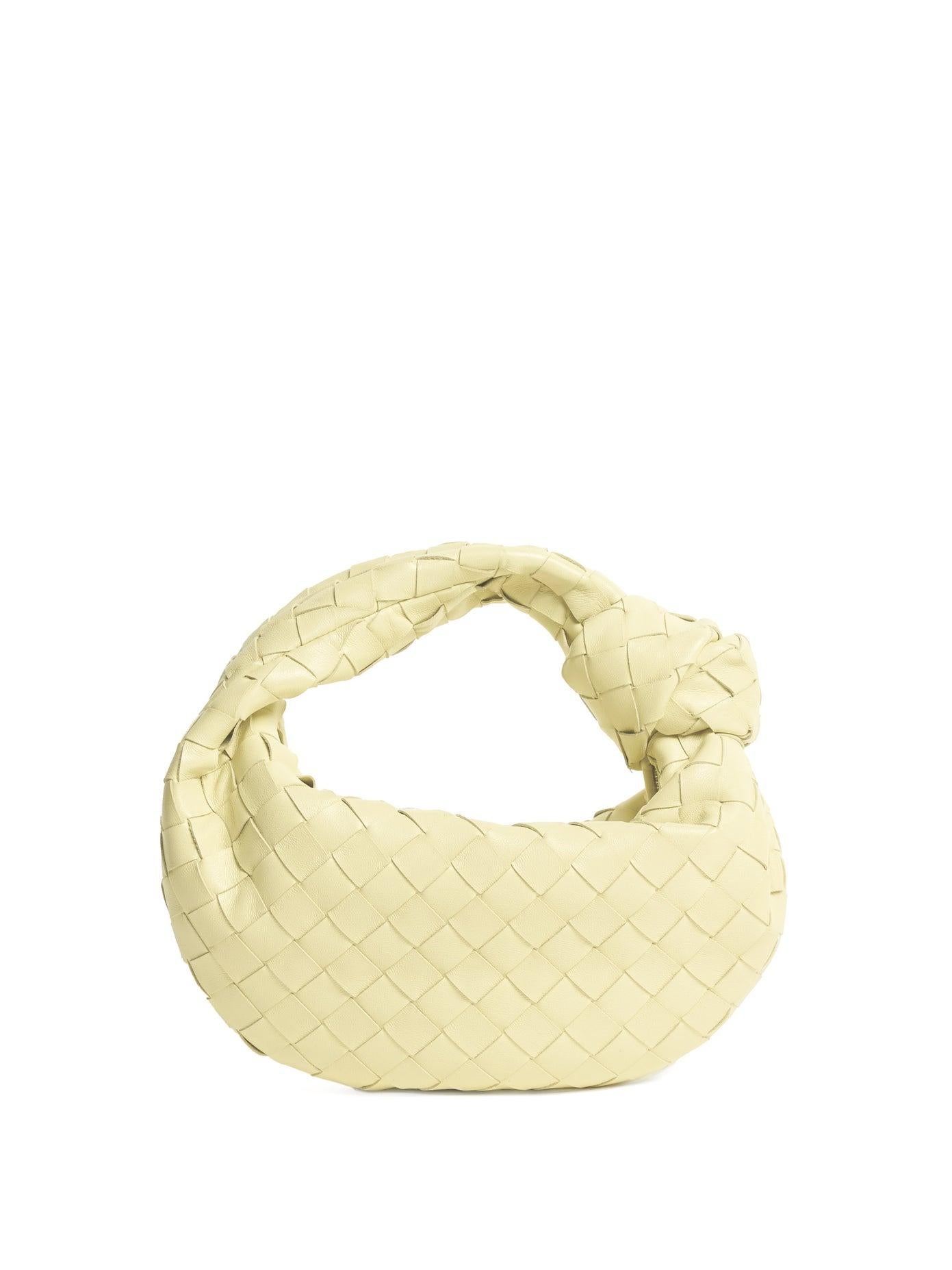 This Bottega bag is made with intrecciato-woven nappa lambskin in a light lemon yellow (ice cream) color. Featuring a fixed shoulder strap, knotted accent at strap base, zip closure, logo embossed at interior, tonal calfskin lining and silver-tone