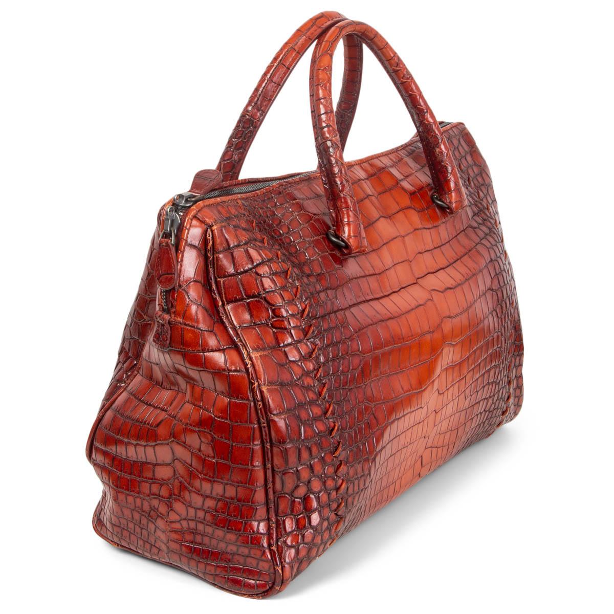100% authentic Bottega Veneta 'Flannel' bag in ombre brick red Cocco Glace crocodile leather. Closes with a two-way zipper on top. Lined in taupe suede with a zipper pocket against the back. Has been carried with a small stain on tje lining. Overall