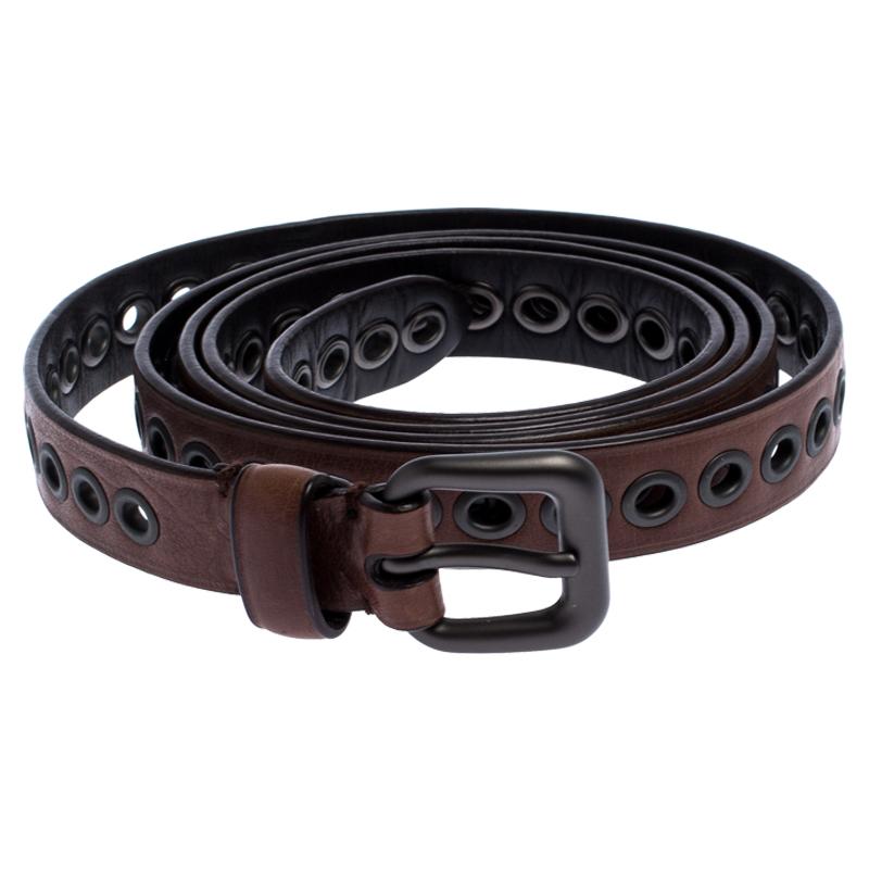 Light up your belt collection by adding this belt from Bottega Veneta. Made from leather, it carries a brown hue along with black-tone eyelets all over. Thanks to the long length, the belt can be double wrapped around the waist. It is will look