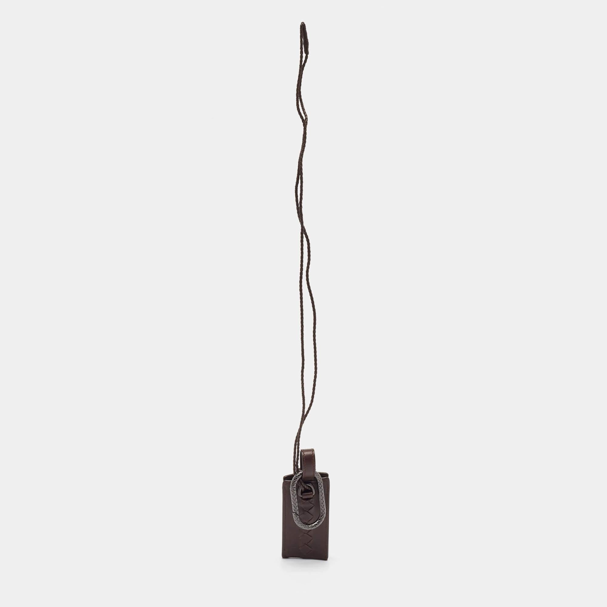 This stylish accessory for your iPod is from Bottega Veneta. Crafted from supple brown leather the case comes with a long strap and flaunts the Intrecciato motif.