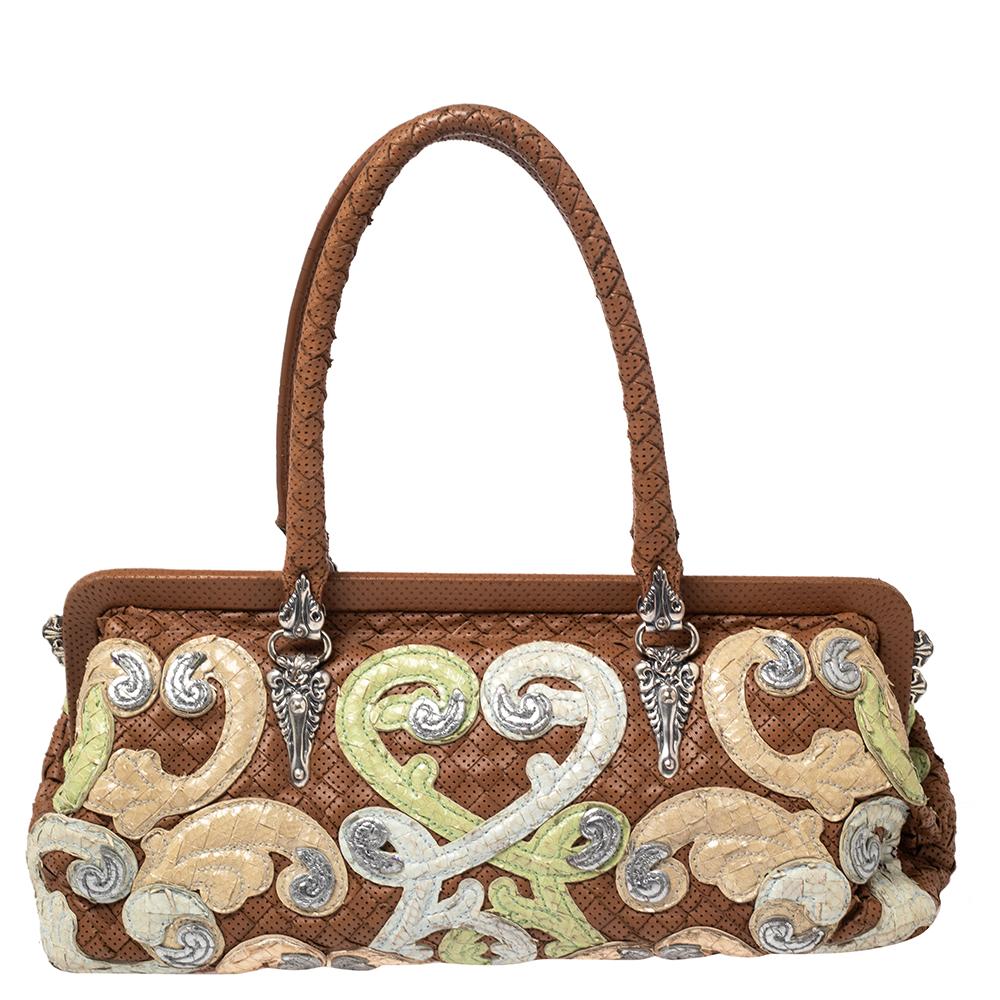 This satchel from Bottega Veneta will add a touch of finesse to your entire appearance. It is made from brown perforated Intrecciato leather on the exterior and features a multicolored embroidered detail all over and silver-toned hardware. It is