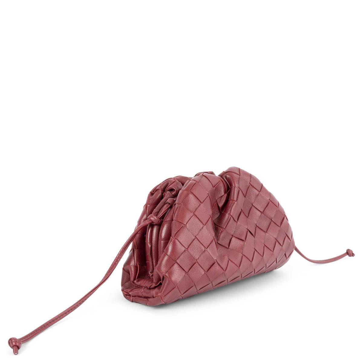 100% authentic Bottega Veneta Mini Pouch in burgundy Intrecciato lambskin. Opens with a magnetic frame closure and has a single compartment lined in calfskin. Has been carried and is in excellent condition. Comes with dust bag.
