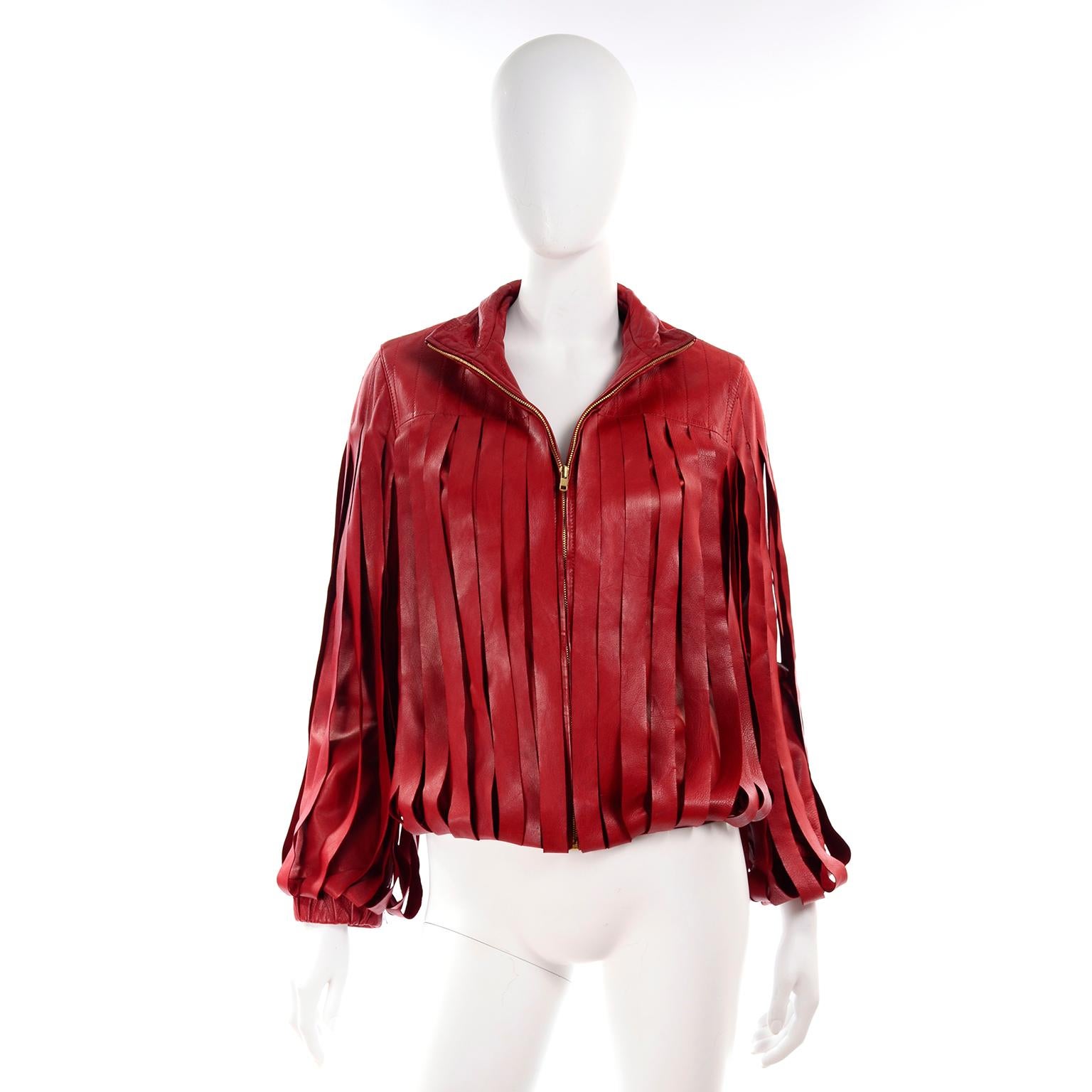 This is an outstanding Bottega Veneta burgundy red leather jacket with gorgeous fringe style panels.  This is probably one of our favorite leather jackets of all time! The coat zips up the front and has topstitching on the upper portion of the front