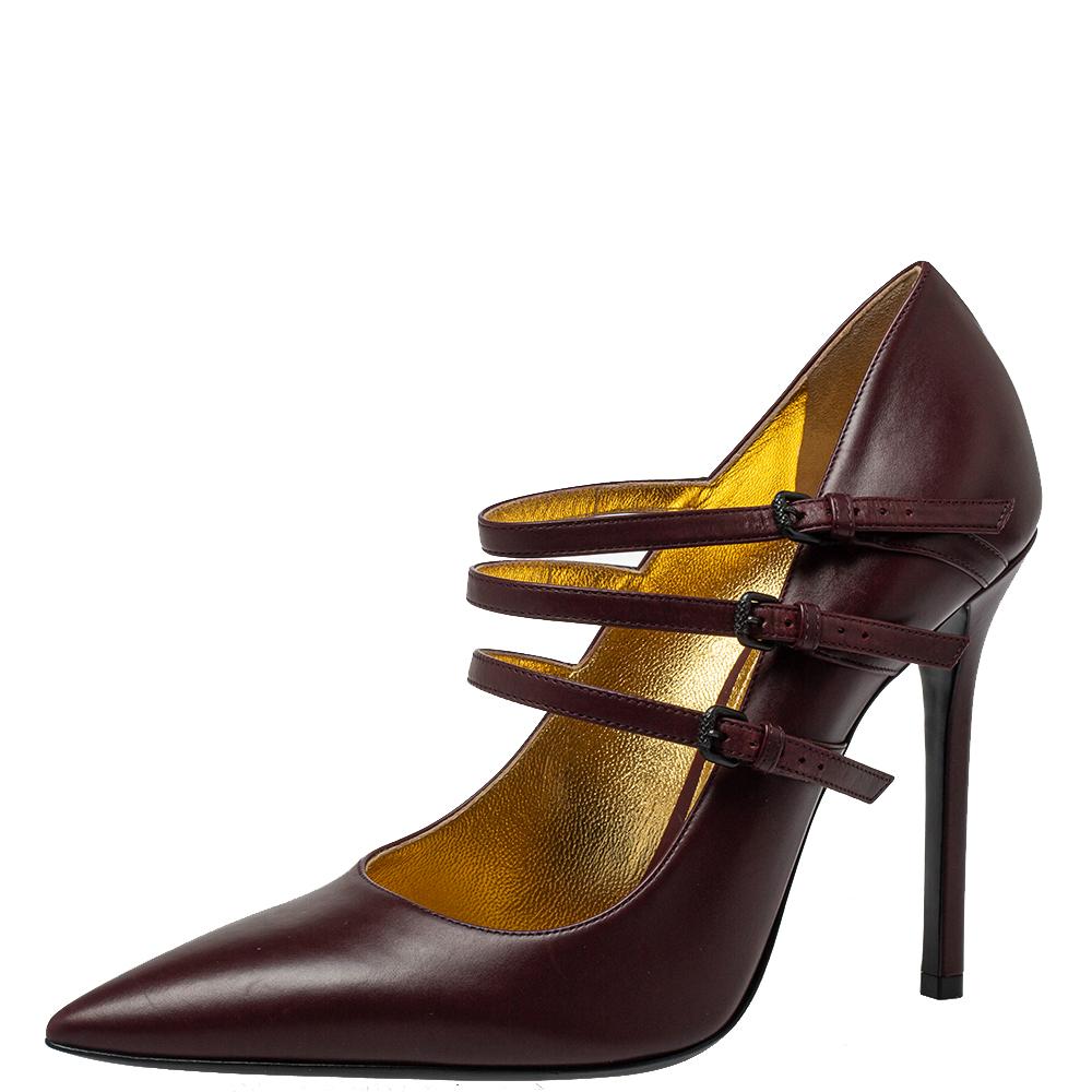 These Bottega Veneta Mary Jane pumps exude a timeless appeal. Crafted from leather in Italy, they feature triple straps with buckle fastening, pointed toes, and 11.5 cm stiletto heels. The burgundy color adds to the appeal of the fashionable