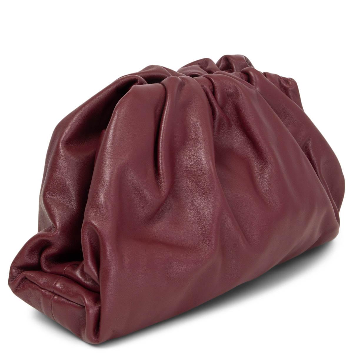 100% authentic Bottega Veneta The Pouch clutch in burgundy smooth leather with a structured upper frame that opens to a spacious interior and closes with a magnetic closure. Has been carried once or twice and is in virtually new condition. Comes