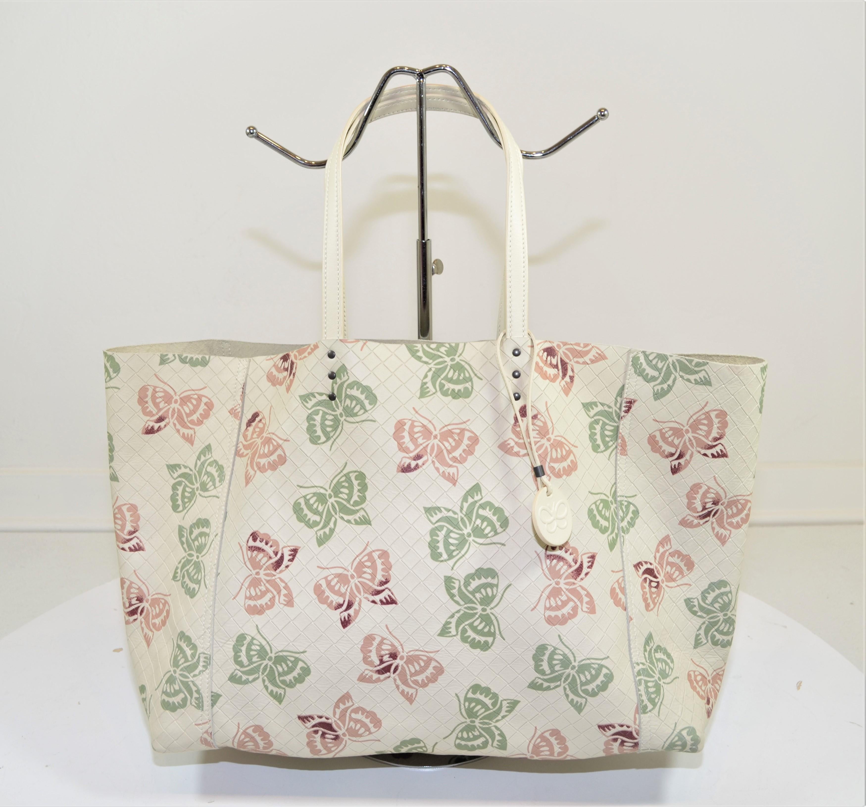 Bottega Veneta tote featured in an off-white/Cream color with woven leather and a butterfly print with flat top leather handles, and a spacious interior. Made in Italy.

Dimensions: 
16” x 5” x 12”, Strap Drop 8”