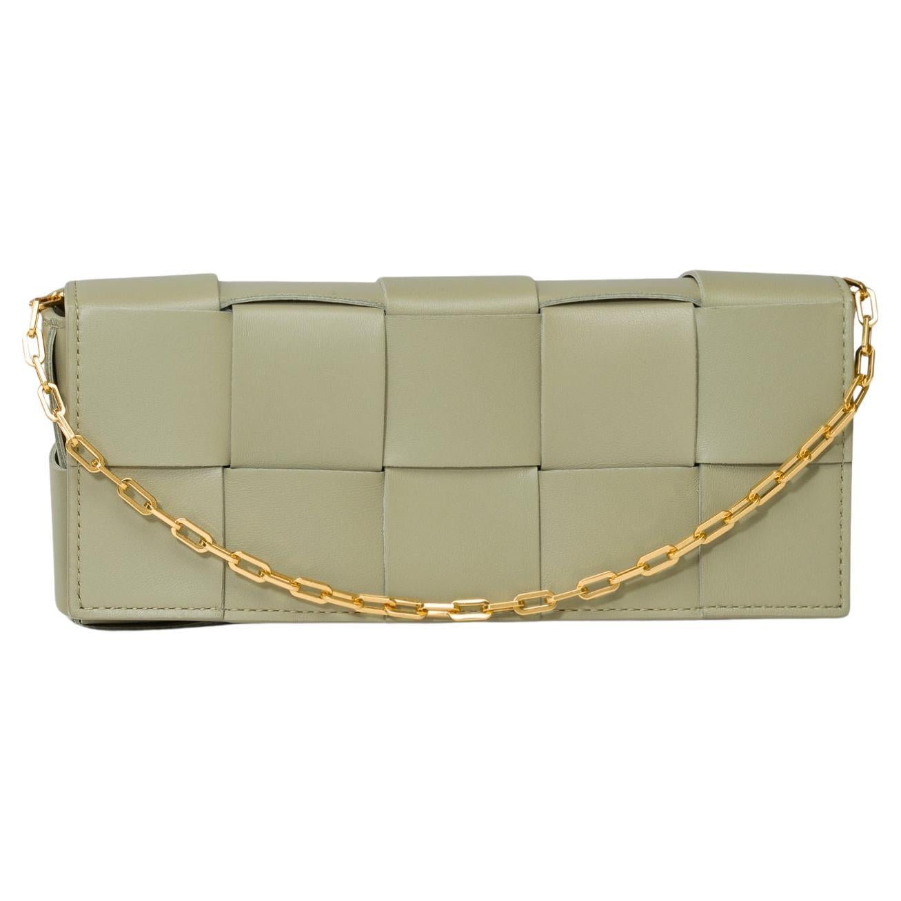 Gorgeous​ ​Bottega​ ​Veneta​ ​Phone​ ​Pouch​ ​Baguette​ ​bag​ ​in​ ​Tavertine​ ​green​ ​Intreccio​ ​smooth​ ​lambskin​ ​leather​ ​,​ ​signature​ ​orthogonal​ ​braiding​ ​with​ ​detachable​ ​chain,​ ​golden​ ​metal​ ​trim,​ ​signature​ ​chain​ ​with​