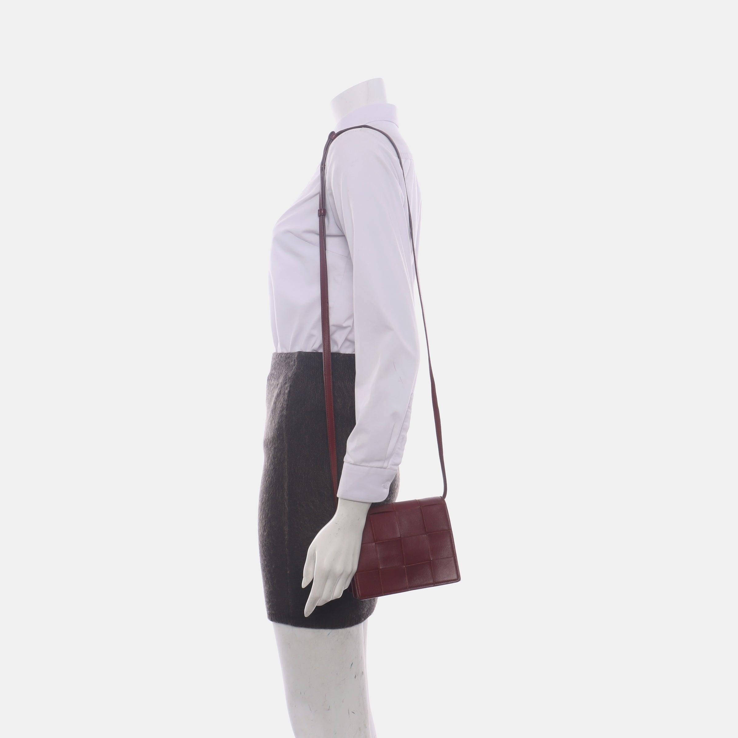 Bottega Veneta Cassette Mini Burgundy Leather Crossbody Bag
 These are professional photos of the actual bag.
 Discover the luxurious craftsmanship of Bottega Veneta with this handwoven Cassette shoulder bag. Boasting an iconic design, its