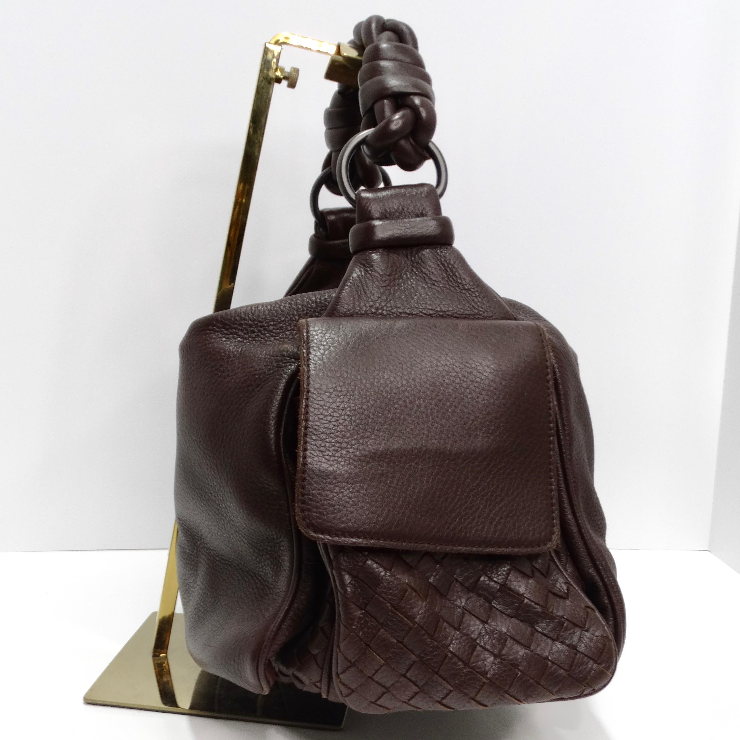 Introducing the Bottega Veneta Cervo Cocker Shoulder Bag, a timeless and versatile accessory designed to elevate your everyday style with understated elegance. Crafted from luxurious brown leather, this hobo-style shoulder bag boasts a chic slouchy