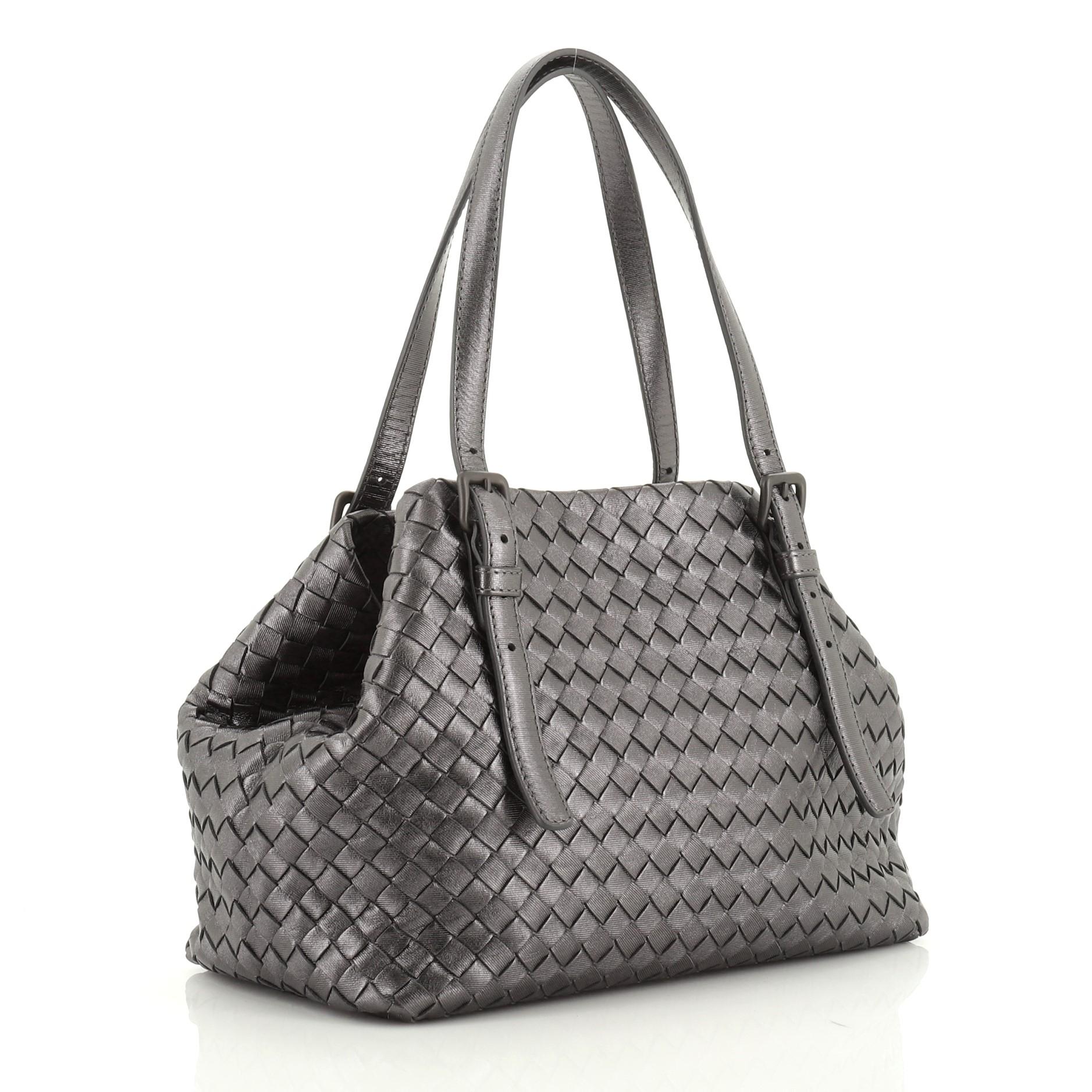 This Bottega Veneta Cesta Tote Intrecciato Nappa Mini, crafted from gray intrecciato nappa leather, features adjustable leather handles and matte gunmetal-tone hardware. It opens to a neutral suede interior. 

Estimated Retail Price: