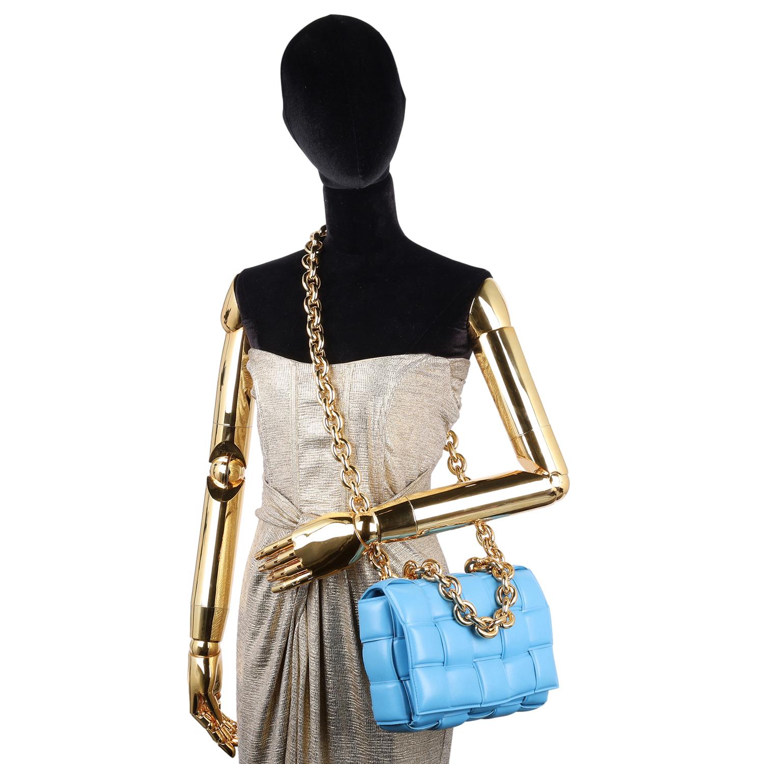 Authentic, pre-owned Bottega Veneta Blue Chain Cassette Bag. Features lavish intrecciato weave on this boxy bag, front flap push lock closure, beautiful Nappa leather in blue, chunky gold chain handle and strap. The blue interior is large with a