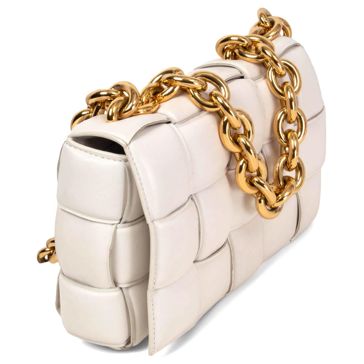 100% authentic Bottega Veneta Chain Cassette Shoulder Bag in chalk Nappa leather featuring chunky chain gold-tone top handle and shoulder strap. Has been carried and shows some soft signs of wear on the front flap, a small light pink mark and on the