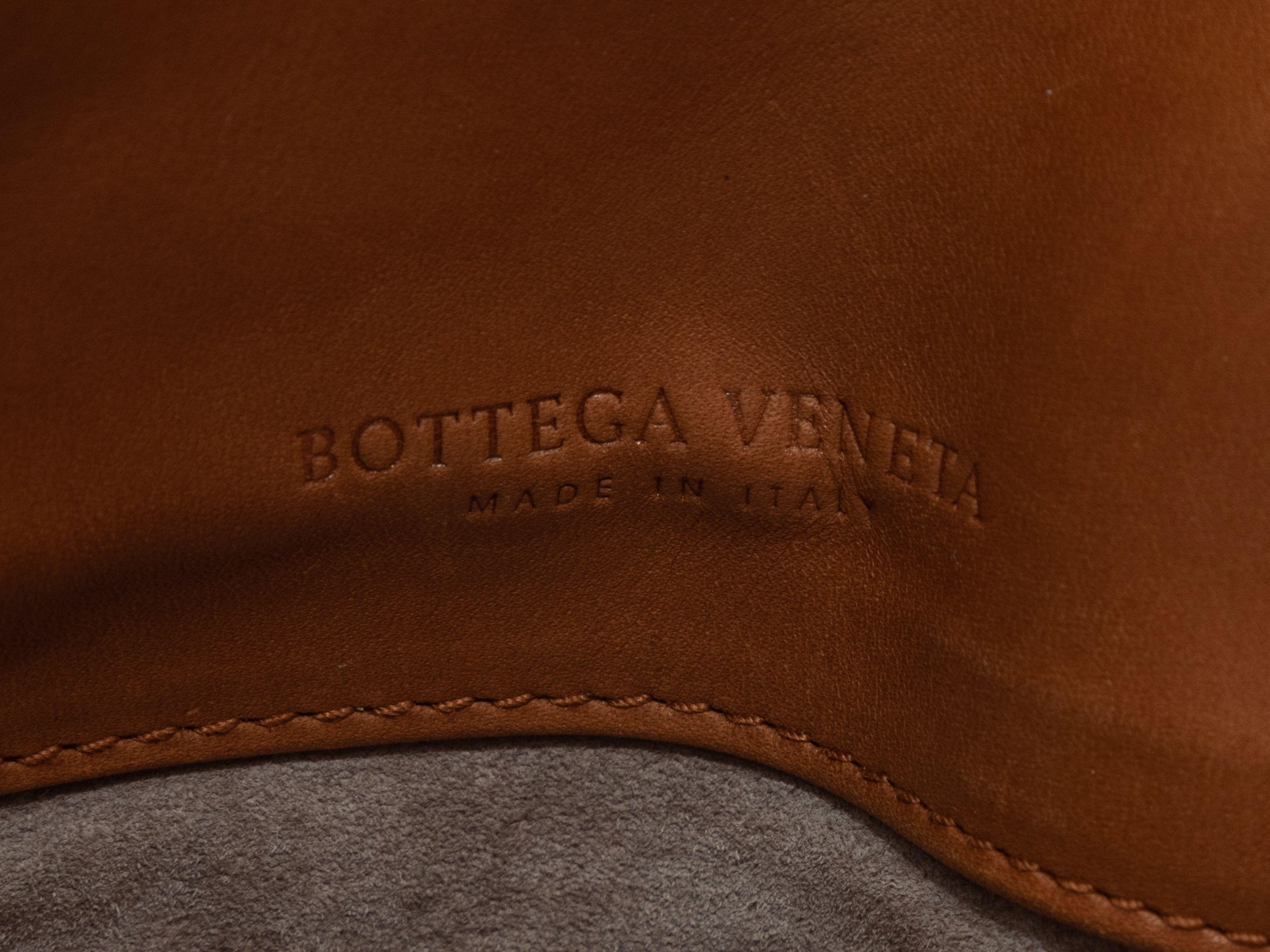 Product Details: Cognac Bottega Veneta Large Leather Tote Bag. This tote bag features a leather body, a taupe suede interior, gold-tone hardware, Intrecciato trim throughout, and a single flat top handle. 17