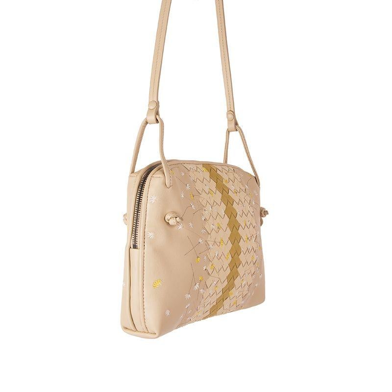 Bottega Veneta 'Nodini' cross-body in sand, cream and chartreuse woven nappa leather. Embellished with flower embroidery. Opens with a two-way zipper on top. Lined in dark taupe suede with one open pocket against the front and a zipper pocket