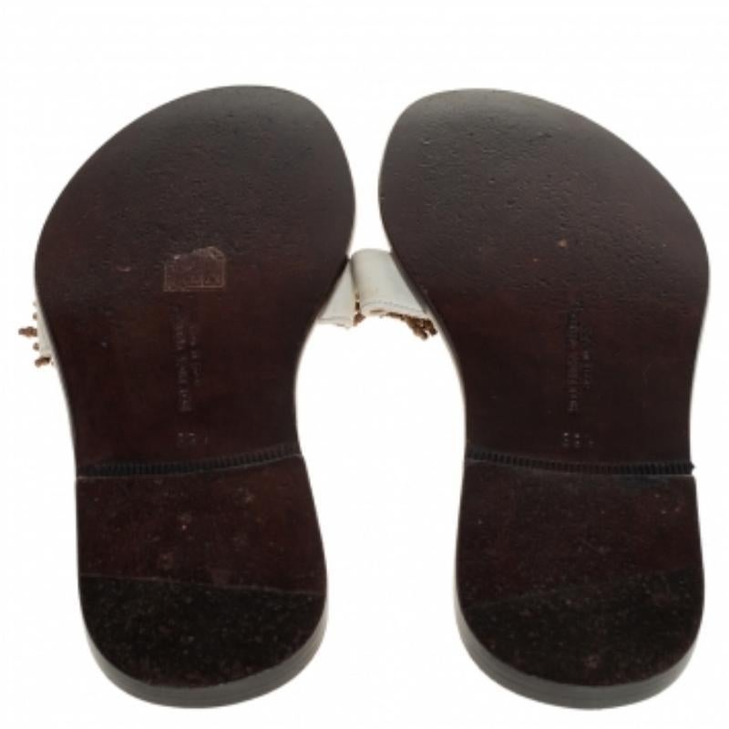 These flats by Bottega Veneta are perfect for summer. They have been crafted from nubuck leather and come in a lovely shade of cream. They have a thong style, embellished uppers and comfortable leather soles.