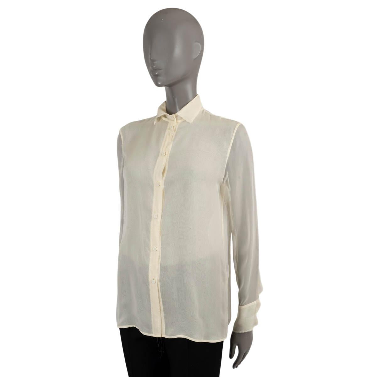 100% authentic Bottega Veneta sheer blouse in cream silk (100%). Features zigzag stitching along the edges with open, frayed hems. Closes with fabric covered buttons on the front. Has been worn and is in excellent condition.