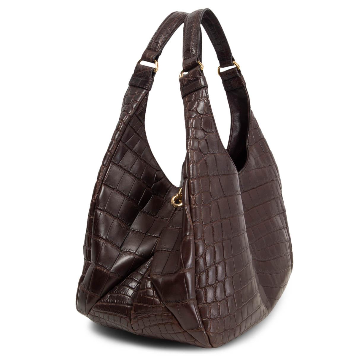 100% authentic Bottega Veneta shoulder bag in espresso brown matte crocodile. Closes with a magnet on top. Lined in light beige suede with a cell phone pocket against the front and a zipper pocket against the back. Has been carried and is in
