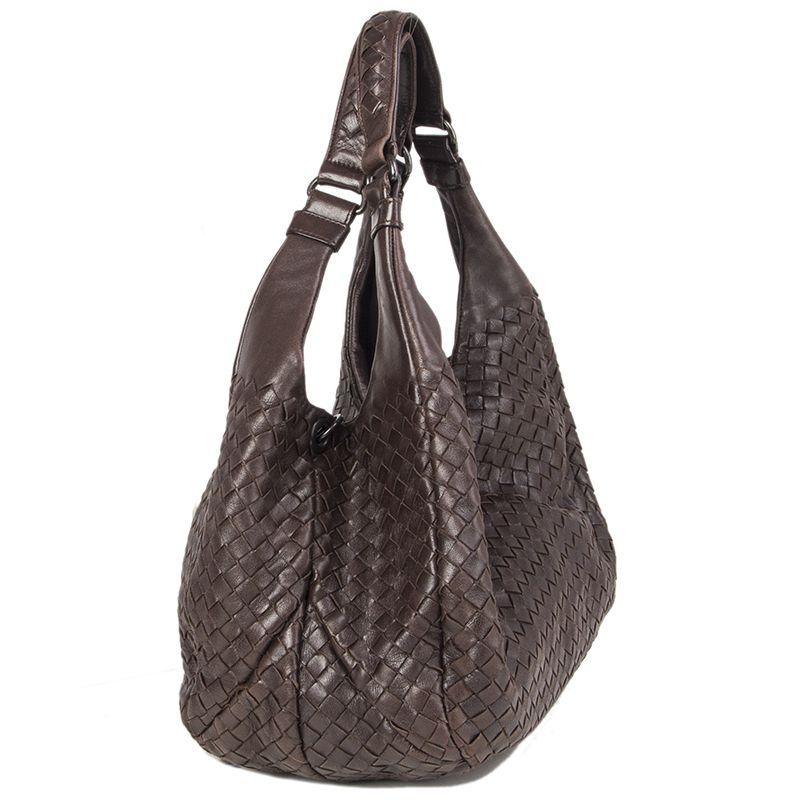 Bottega Veneta 'Campana Medium' shoulder bag in dark brown leather. Opens with a hidden magnetic button on top and is lined in beige suede with one zipper pocket against the back and a cell phone pocket against the front. Comes with a key strap