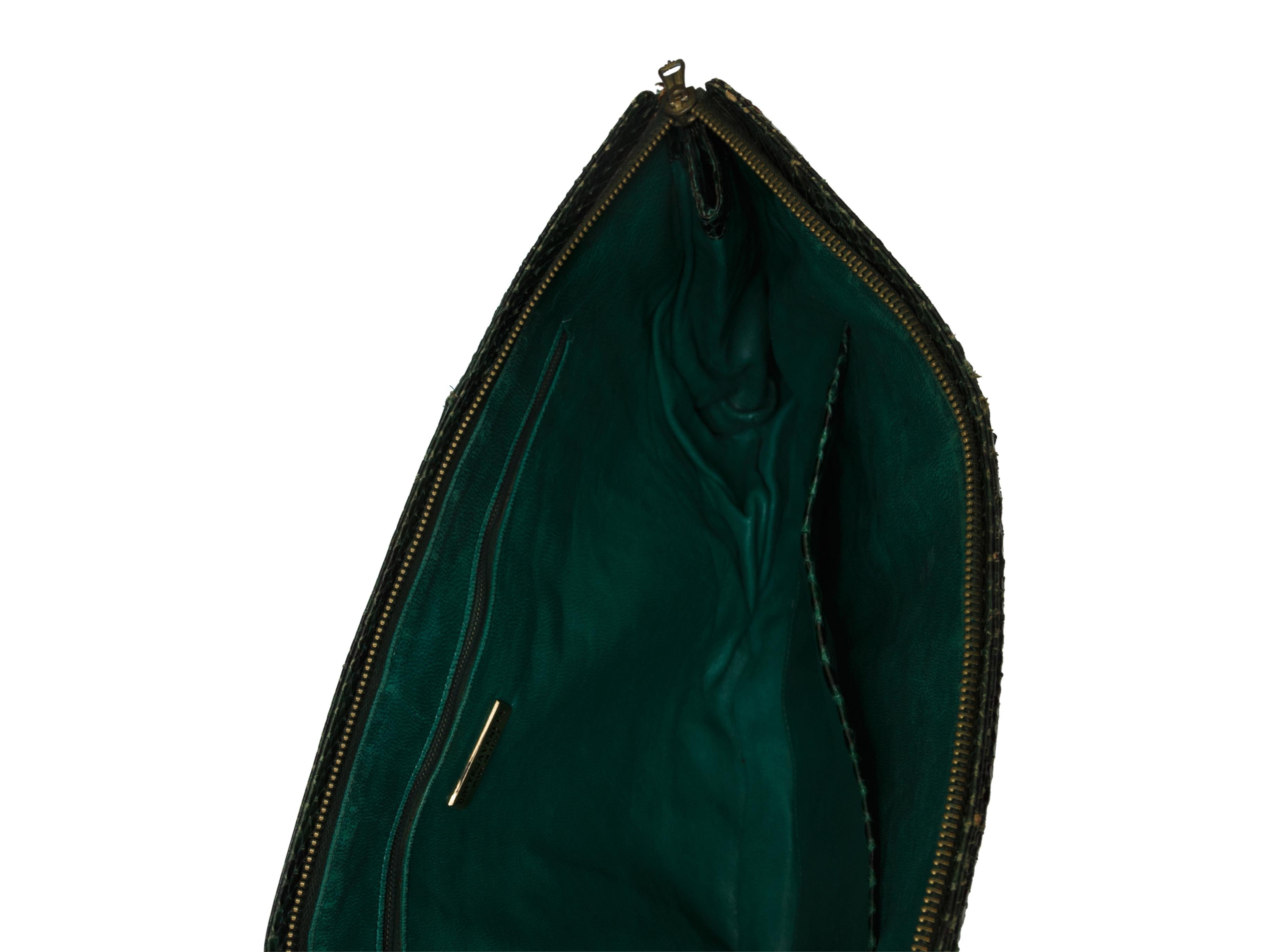 Product details: Dark green snakeskin clutch by Bottega Veneta. Interior pockets. Zip closure at top. 17