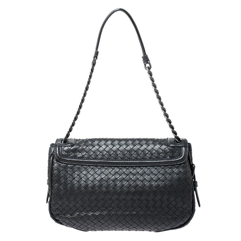 Crafted from leather using their famous Intrecciato technique, this bag from Bottega Veneta features a flap design. The dark grey bag has a shoulder chain with leather rest and a well-sized suede interior to hold your essentials.

