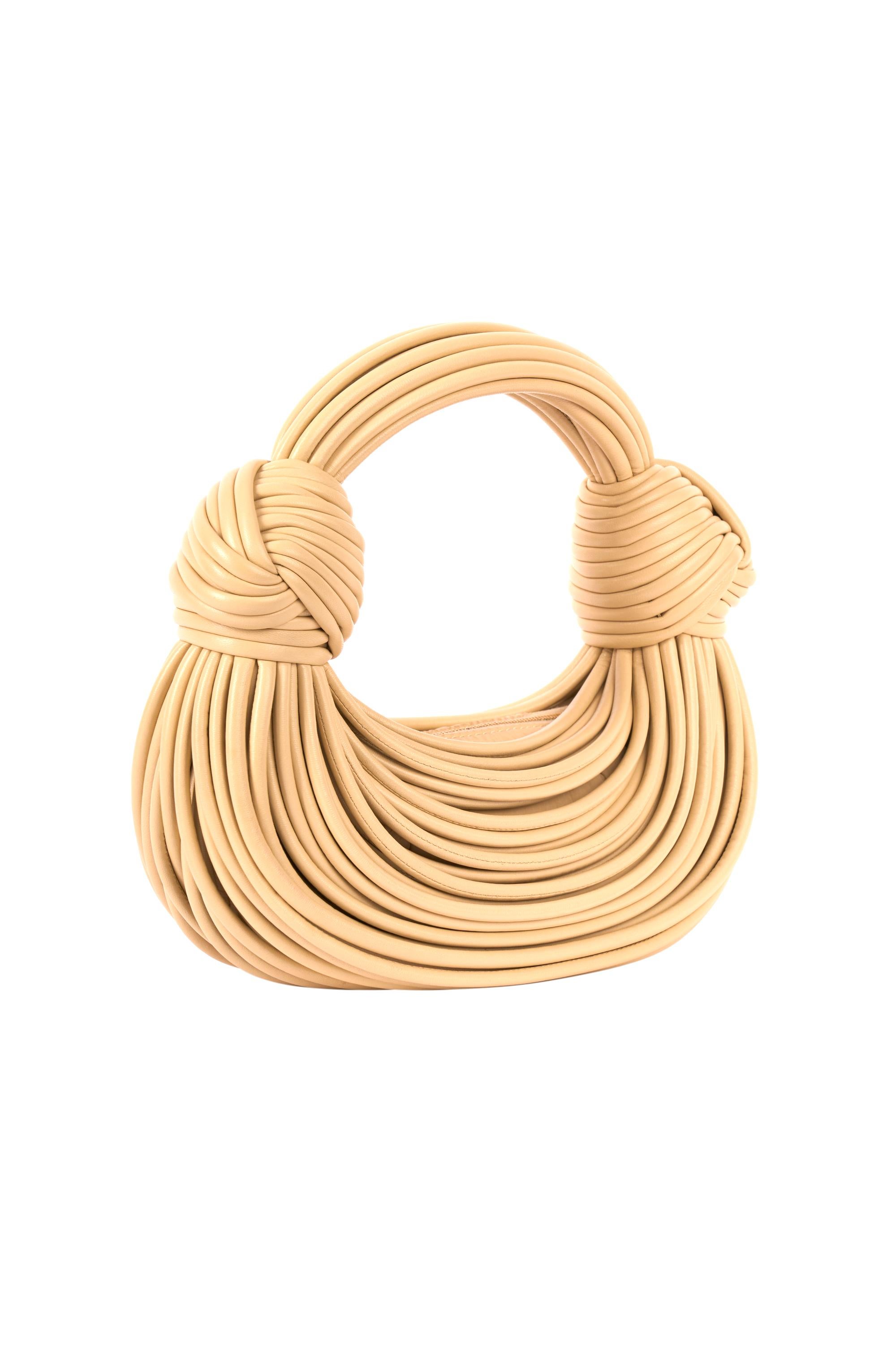 Bottega Veneta beige double knot small leather tote. Feature a beige nappa leather and double knot details at the handle. Fasten with a top handle zipper.

Authenticity Guaranteed

Brand: Bottega Veneta
Color: Beige
Year/ Season :
Tote bag
Fabric: