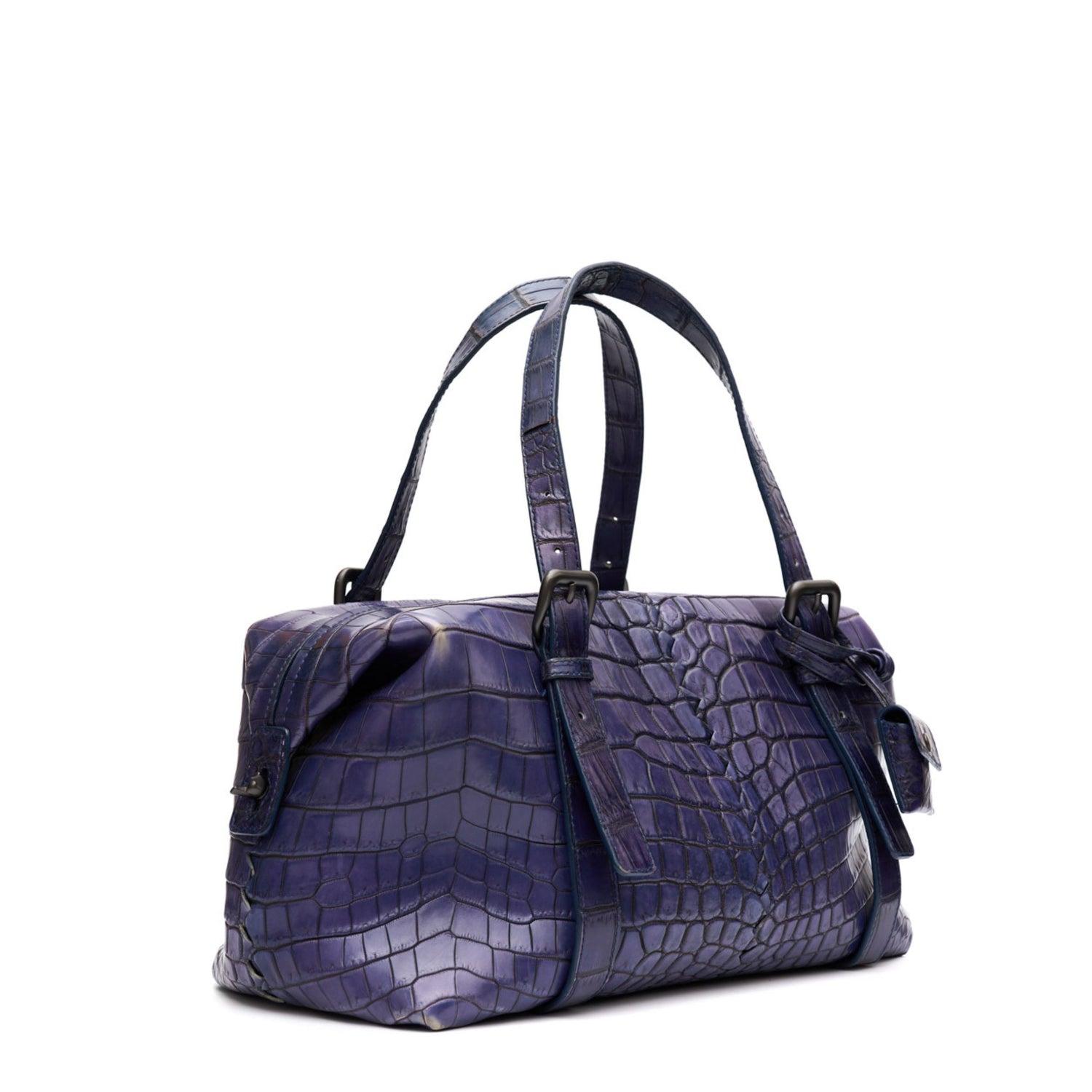 Purple

Two adjustable top handles
Gunmetal-tone hardware
Comes with key and lock

Zip up closure
Suede lined interior
Inner slip pockets and zip pocket
Condition: Very Good
This pre-loved bag is in very good condition, with some faint