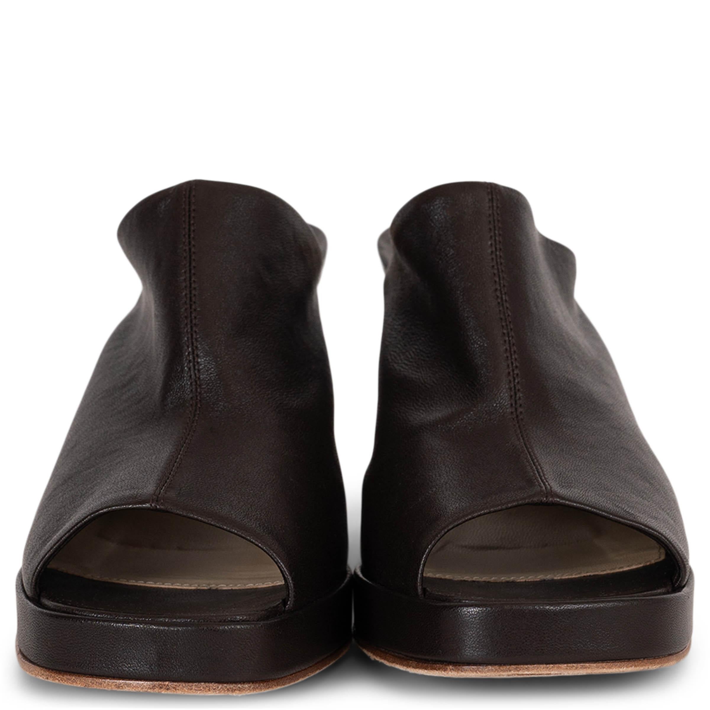 This 100% authentic Bottega Veneta Stack mule sandal in Fondant (dark brown) leather showcases sculptural elegance. Designed with open square toes, a leather-covered wedge heel, and a slight platform, the slip-on silhouette offers both bold style