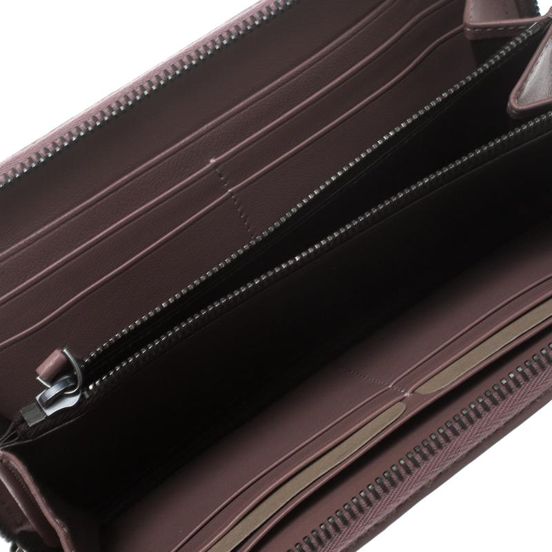Luxe and classy, this zip around wallet is from Bottega Veneta. It has been crafted from leather using their signature Intrecciato weave technique and equipped with a zipper leading to multiple slots and a zip pocket for you to neatly carry your