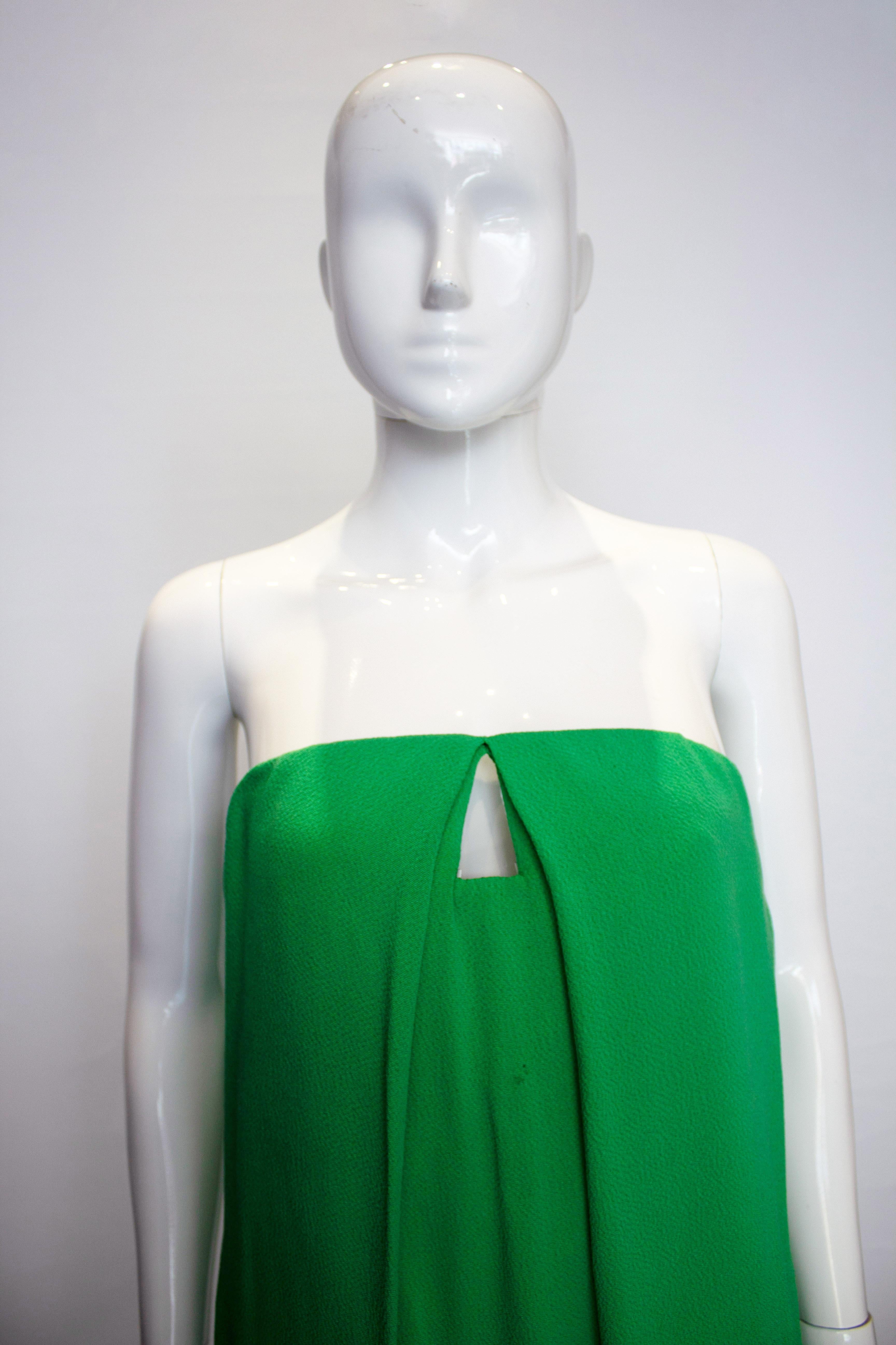 A chic cocktail dress by Bottega Veneta in a pretty green colour. The dress is strapless with internal boning and bra cups. It has a side zip opening, is fully lined and has one pocket.