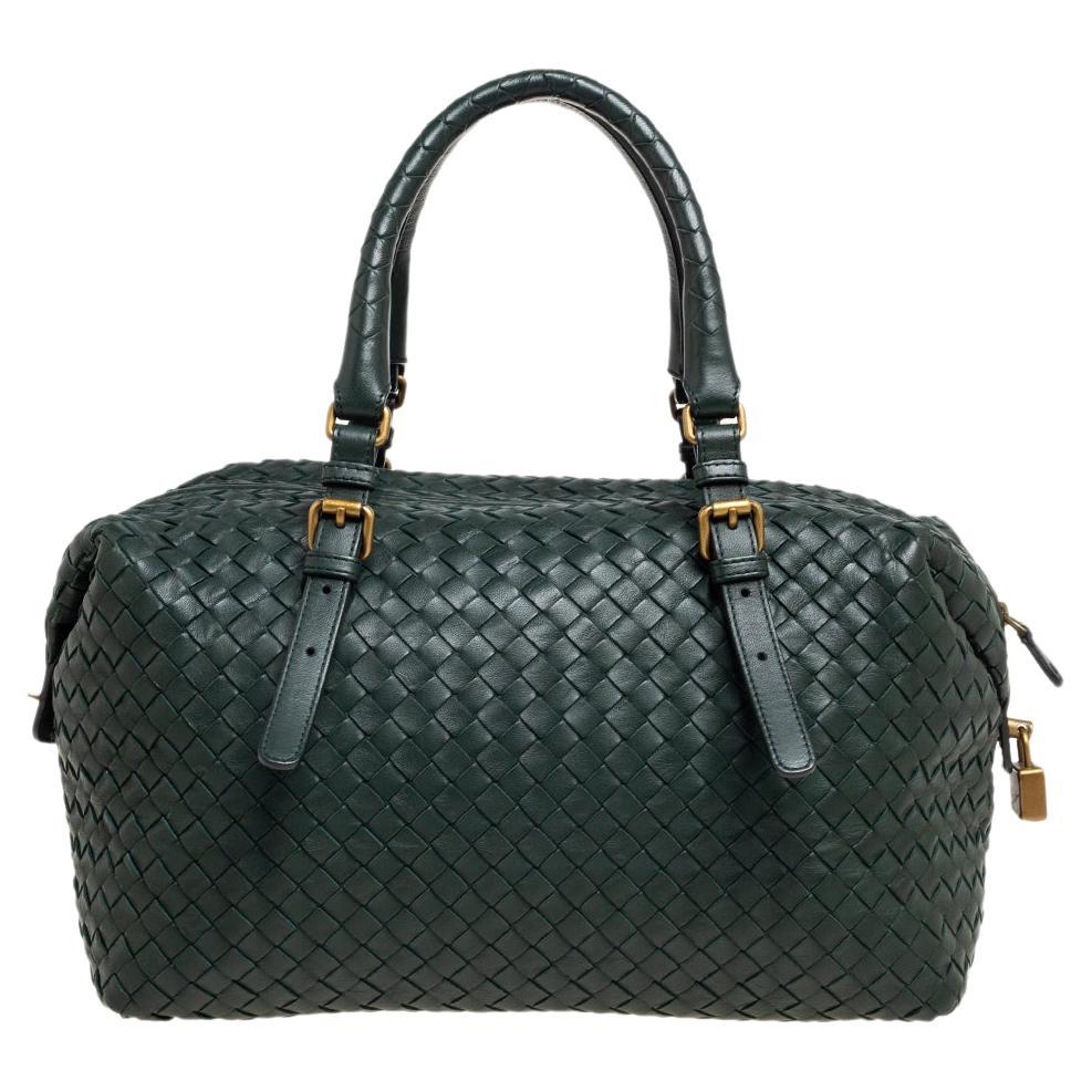 Bottega Veneta's Boston bag presents the label's artistry in fine craftsmanship and classic designs. Woven in their Intrecciato technique, it features a green shade, dual handles, and a well-sized interior for your essentials.

