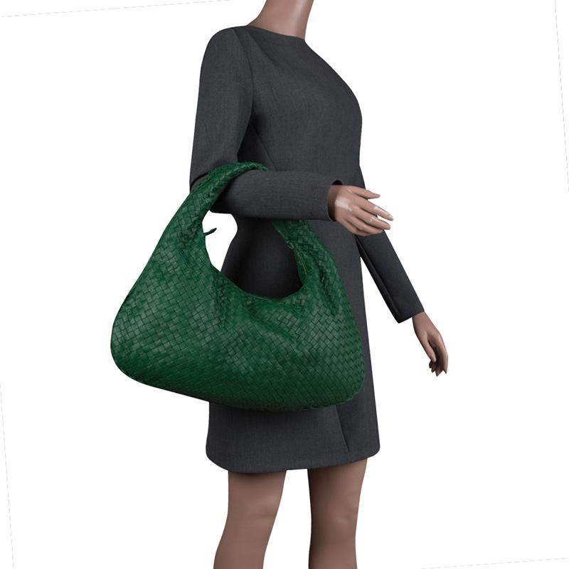 This hobo from Bottega Veneta is the perfect bag to carry while travelling. Crafted with intrecciato leather, it features a gorgeous green hue and a top zipper closure. It has a suede interior that is spacious to organise all your essentials. The