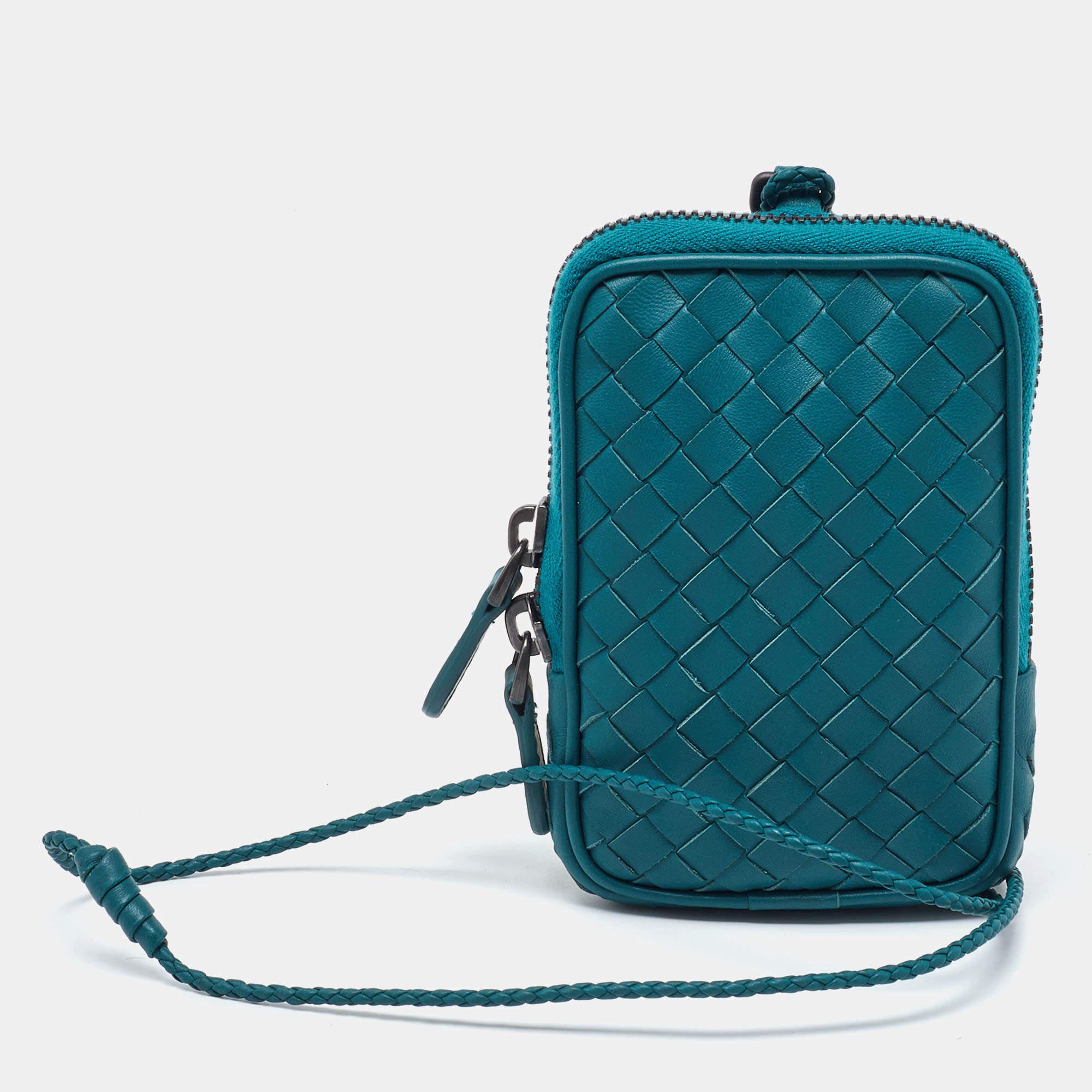 The Bottega Veneta pouch is a luxurious accessory crafted from high-quality green leather. It features the brand's signature woven pattern, a secure zip closure, and a spacious interior for organizing essentials. This elegant pouch exudes