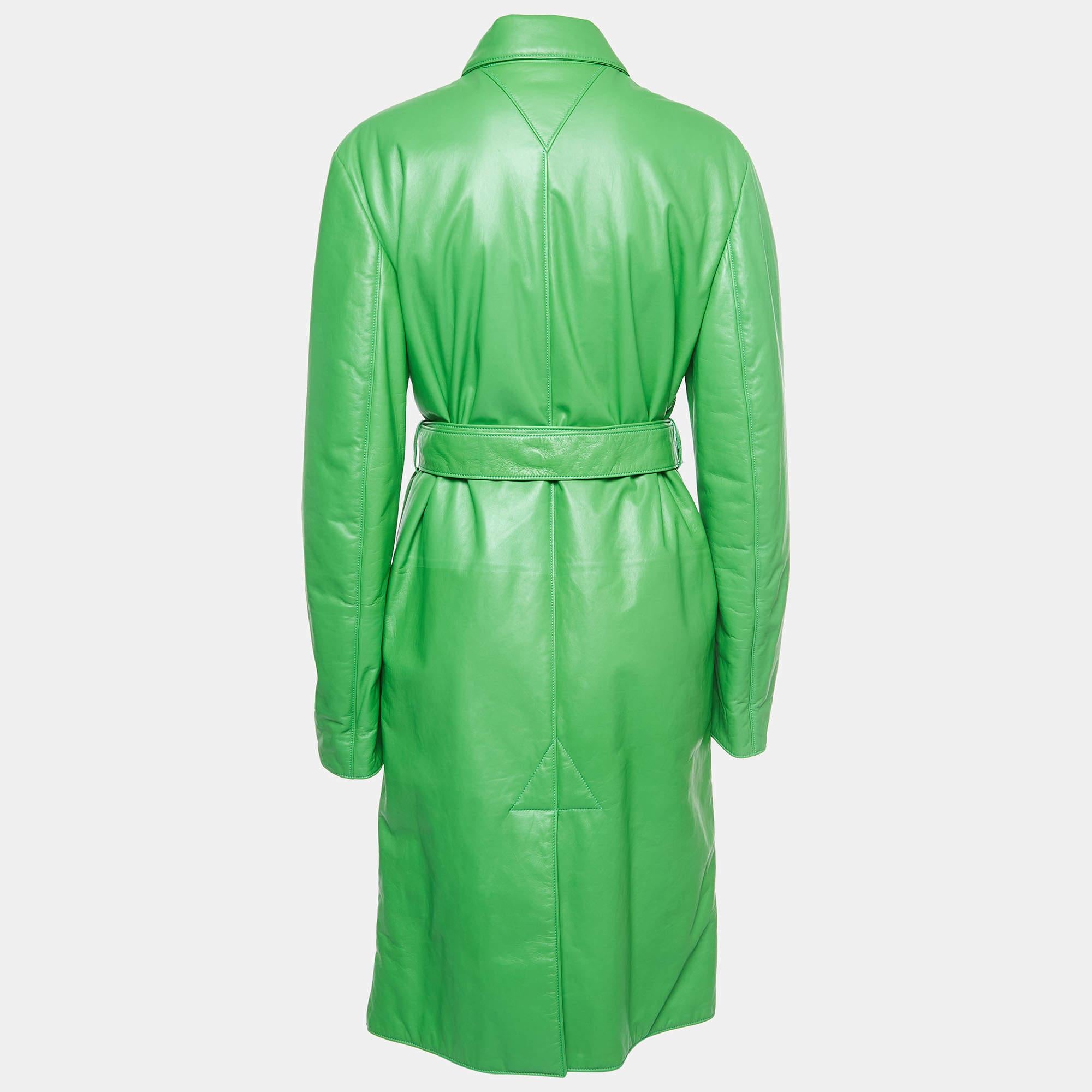 Elevate your wardrobe with the Bottega Veneta trench coat. Meticulously crafted from sumptuous lambskin, this coat boasts a sleek silhouette and a rich green hue. With its tailored fit, classic lapels, and timeless appeal, it epitomizes