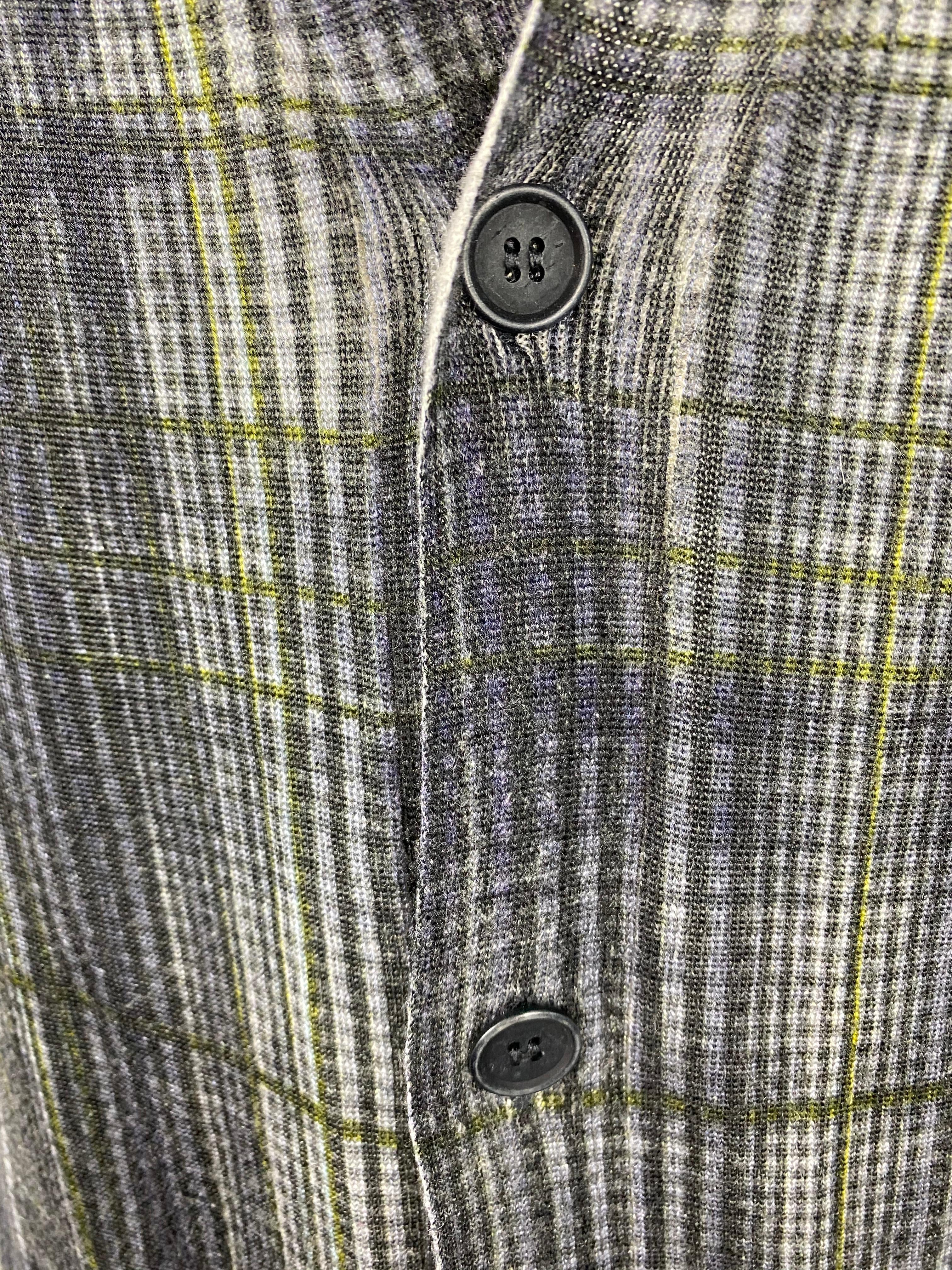 Product details:

Featuring grey and green plaid pattern, v neck line, front five button down closure.
Made in Italy.