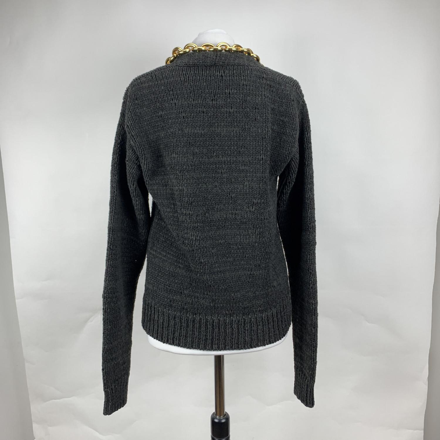 Bottega Veneta dark grey cotton sweater with gold metal chain chain detailing (the color of the sweater is a mixture of dark gray and brown). From the 2020 Pre-Fall collection. Knitted design, V-neck, long sleeve styling and straight hem.