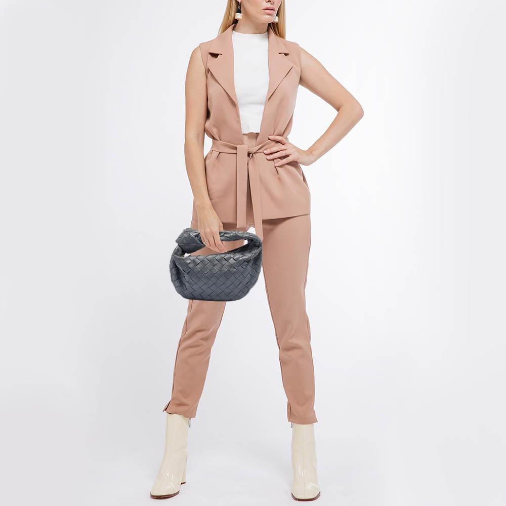 The Bottega Veneta Jodie Hobo exudes timeless charm with its iconic woven design. Crafted from sumptuous leather, this bag features a knotted handle, adding a touch of artisanal flair. Its spacious interior and understated silhouette make it a