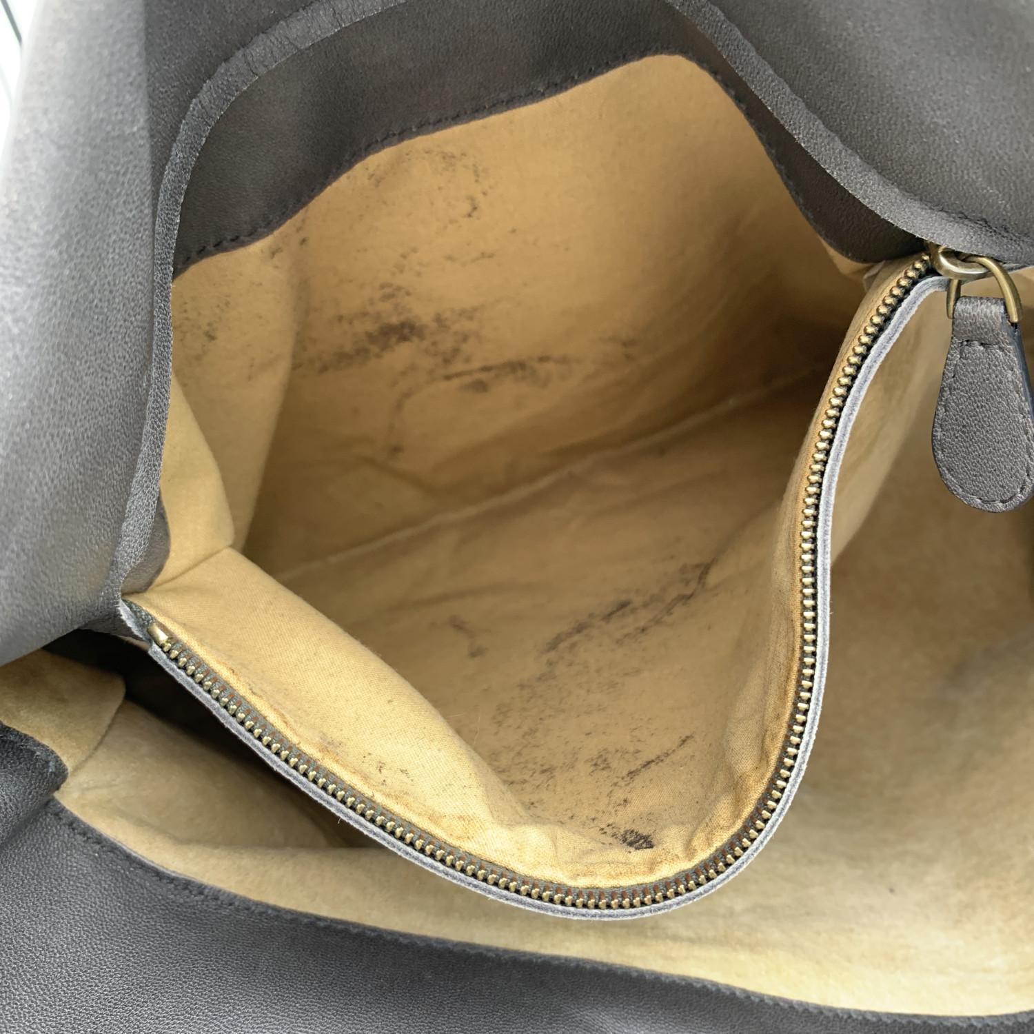 BOTTEGA VENETA Intrecciato woven 'Roma' leather tote bag in grey color, with gold metal hardware. Fold over strap with key closure. 3 main compartments. Beige suede lining with 1 side zip pocket and 1 side open pocket inside. 'BOTTEGA VENETA'