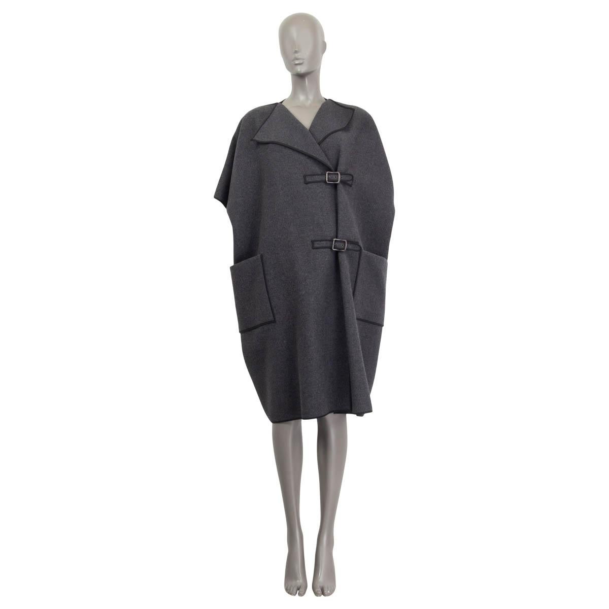 100% authentic Bottega Veneta cape in gray wool (80%) and angora (20%) with black cotton details at the sleeves,collar and hemline. Features short raglan sleeves (sleeve measurements taken from the neck) and two front patch pockets. Closes on the