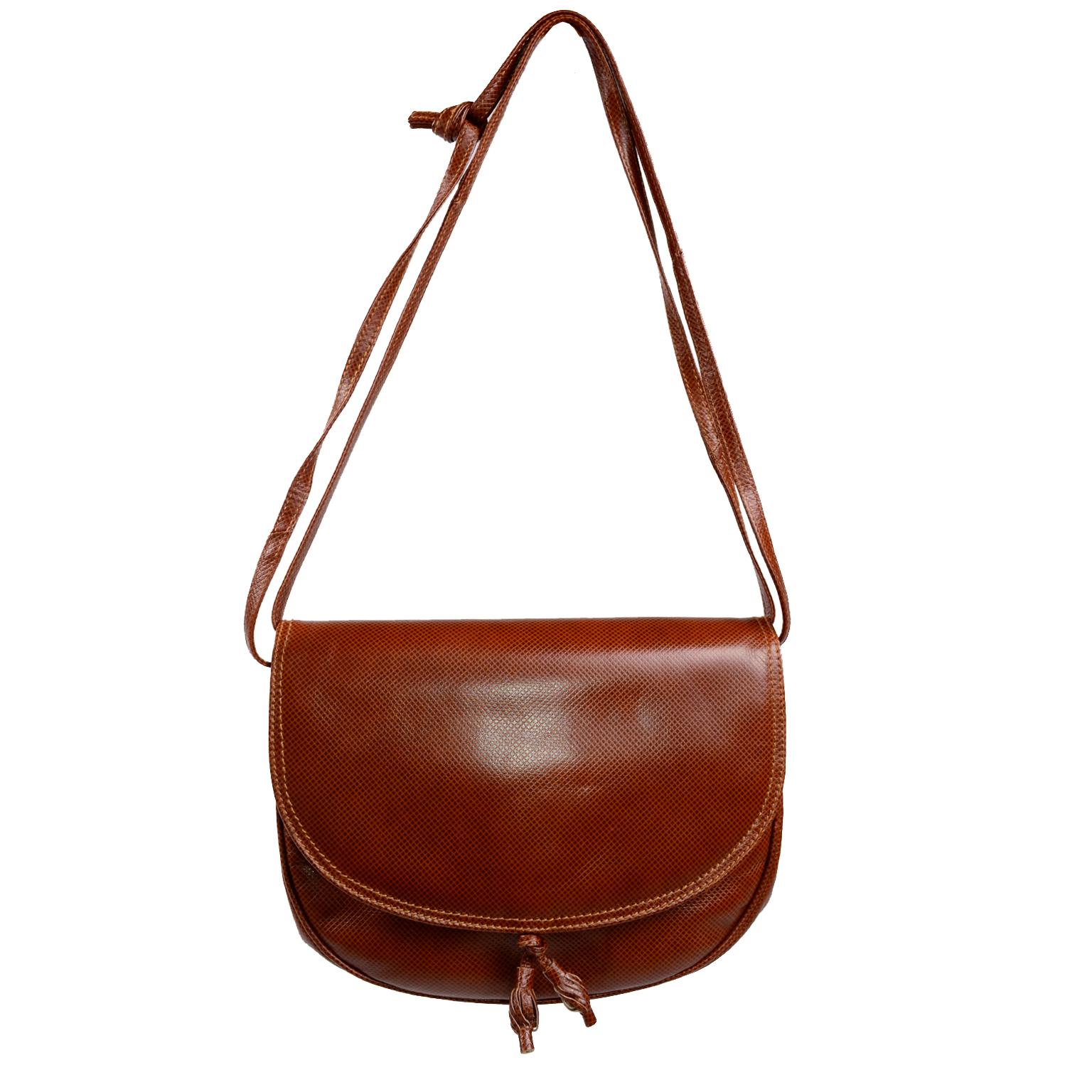 This is a nice vintage Bottega Veneta Caramel Leather Crossbody flap Bag. The bag can also be a shorter shoulder bag when the straps are doubled.There is another flap under the main flap with a pocket and it closes with a snap. There is another