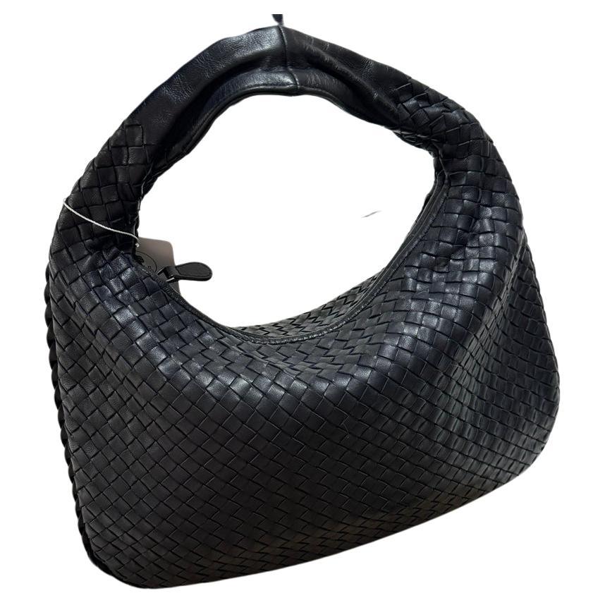 This Bottega Veneta Hobo Bag is an exceptional piece of luxury, crafted from lambskin leather with the instantly recognizable Intrecciato weave. Measuring 40cm wide at the base, roomy enough for all your essentials, it's the perfect winter accessory