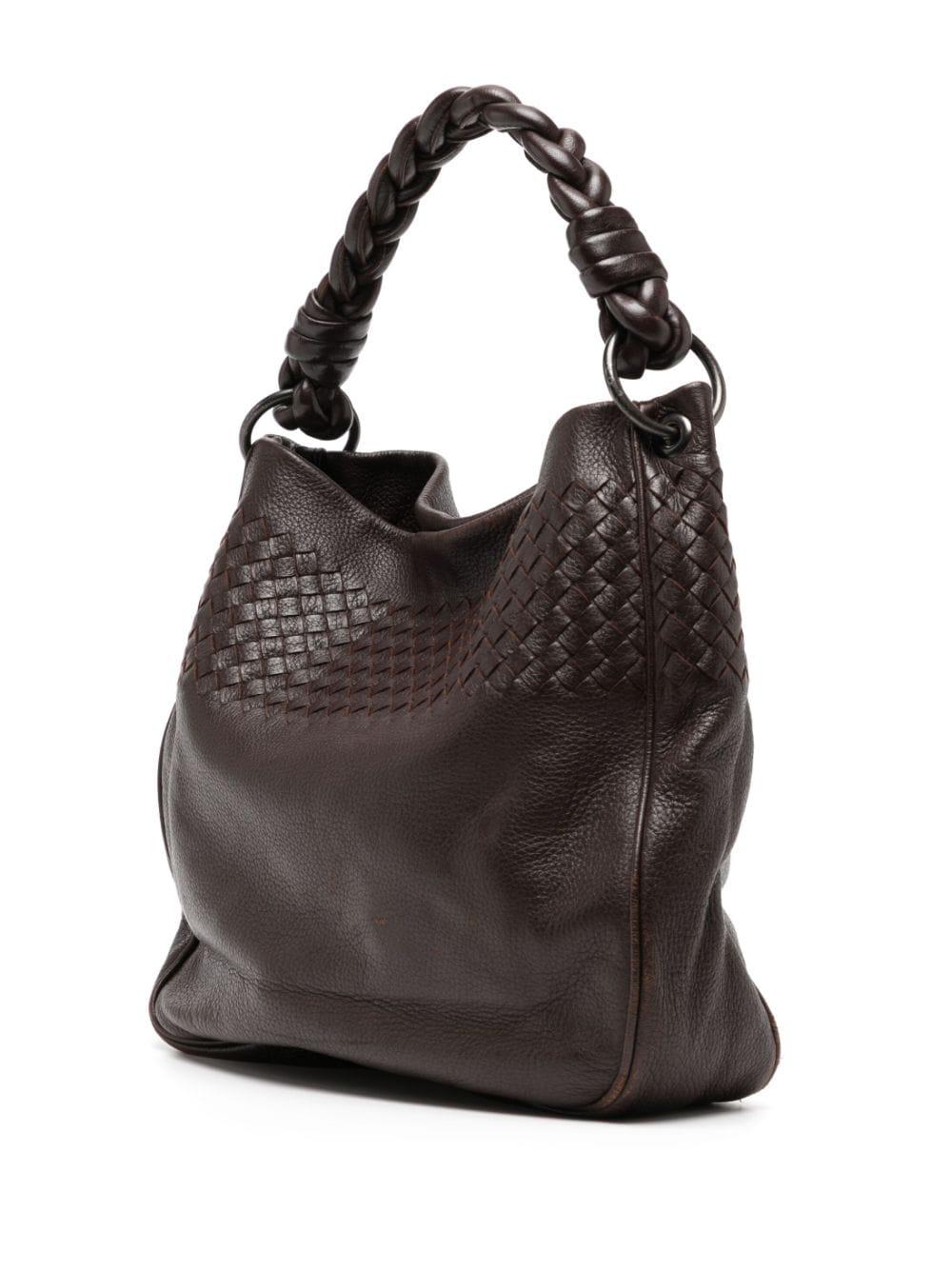 Expertly crafted in Italy, this Bottega Veneta Hobo Bag in coffee brown is made of 100% leather in the signature intrecciato technique. Featuring a single braided top handle, concealed magnetic fastening and silver-tone hardware.  This bag is in