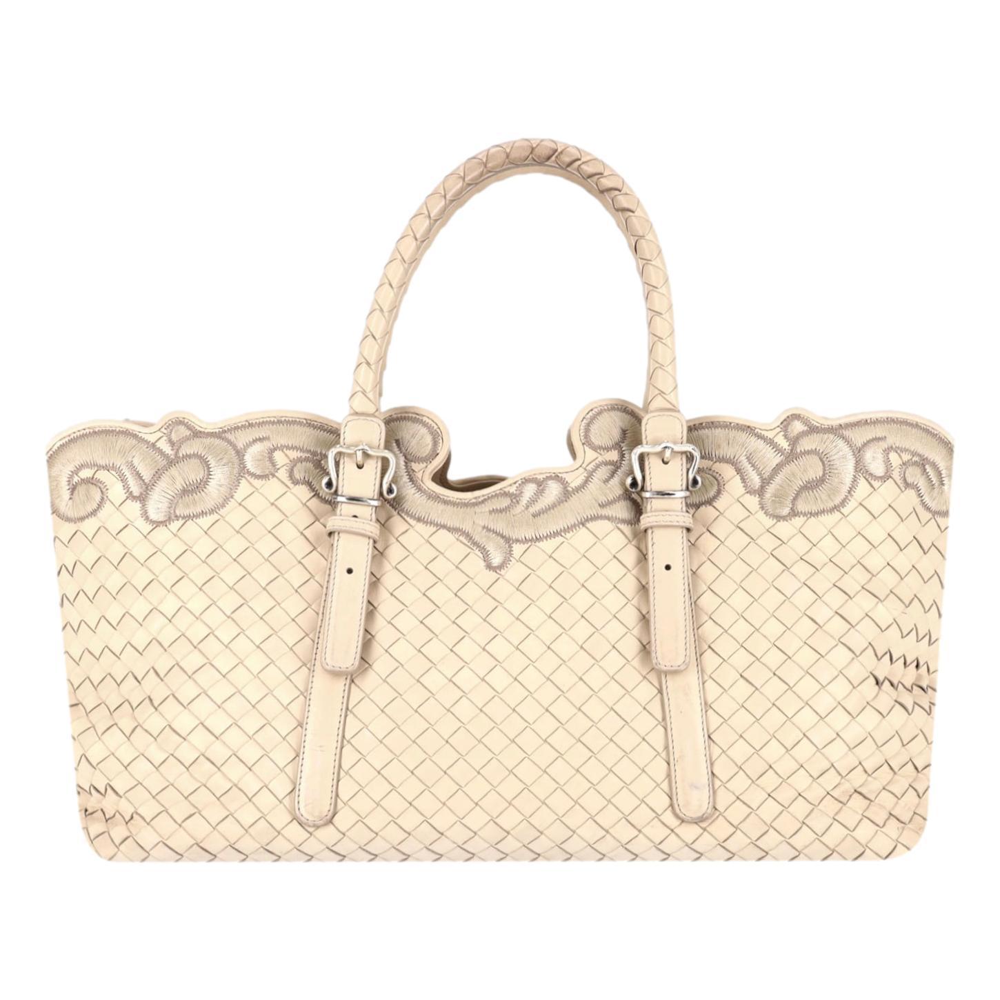 Bottega Veneta Intrecciato Leather Embroidered Trim Tote Bag

Ivory handbag crafted from signature Intrecciato leather and adorned with a decorative embroidery trim.

Featuring silver hardware, adjustable dual top handles and zipped top leading to