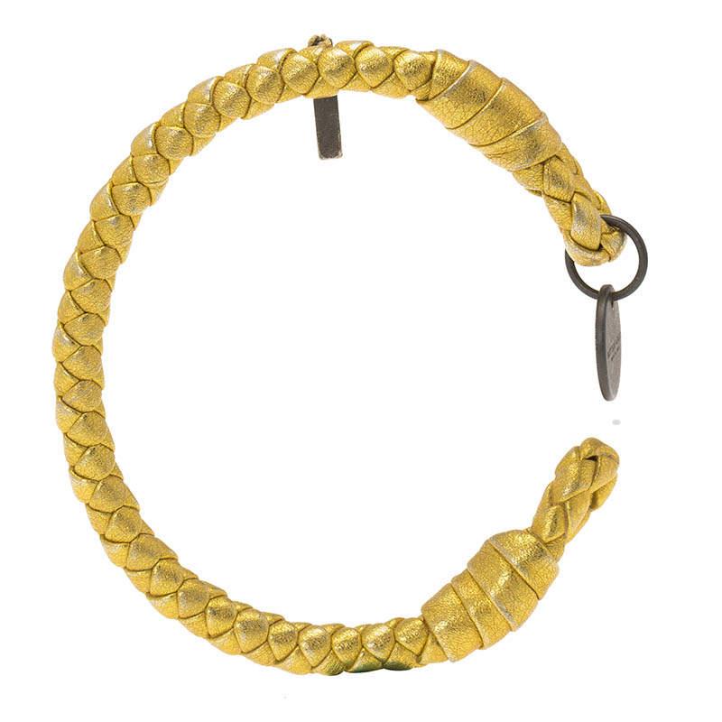 Its unmistakable intrecciato weave makes this bracelet distinctly Bottega Veneta. Made from leather, it is lightweight and comfortable to wear. A gold-tone body is accented by a Bottega Veneta charm, adding to its design. An open cuff design allows