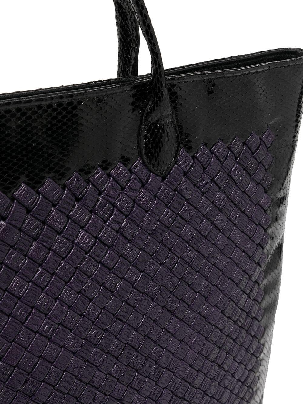 A rare and limited-edition piece from Bottega Veneta, this stunning pre-owned bag displays their quality craftsmanship and has been crafted from a rich purple and black leather the iconic intrecciato weave, which is a signature design of the brand.