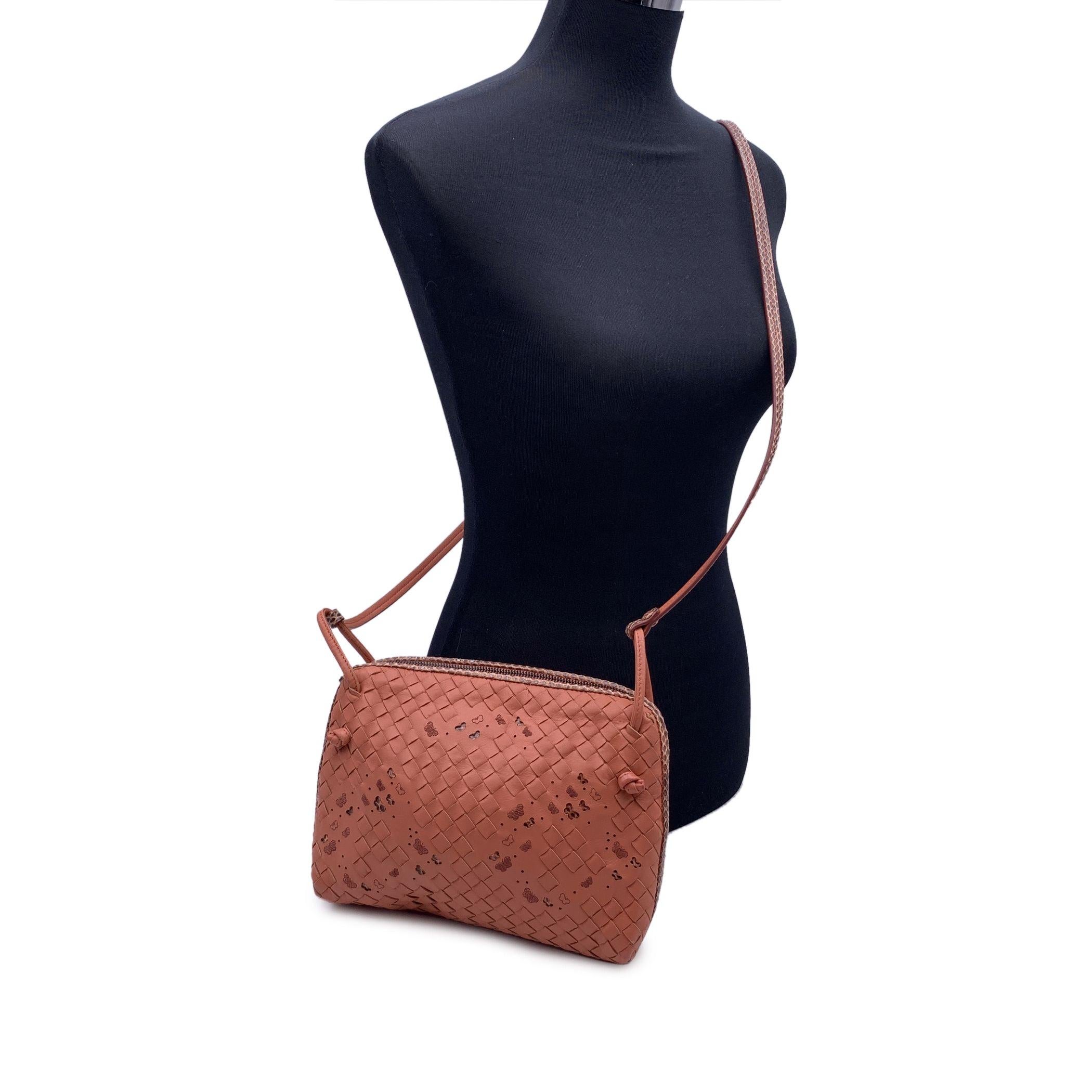 Bottega Veneta 'Butterfly Nodini' shoulder bag in pink Intrecciato woven nappa leather and Ayers leather with cutout butterfly details. Upper zipper closure. Beige suede lining. Bottega Veneta - Made in Italy' tag inside. Bottega Veneta