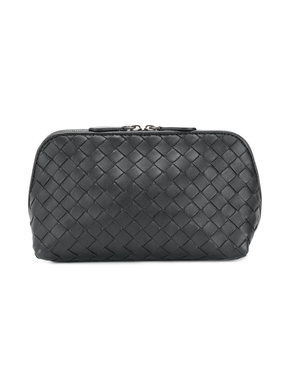 This handily sized black leather intrecciato woven vanity case featuring a top zip fastening and a main internal compartment. Perfect for a top shelf, or organising essentials in one's handbag.

Material: Nappa leather

Colour: Black

Measurements: