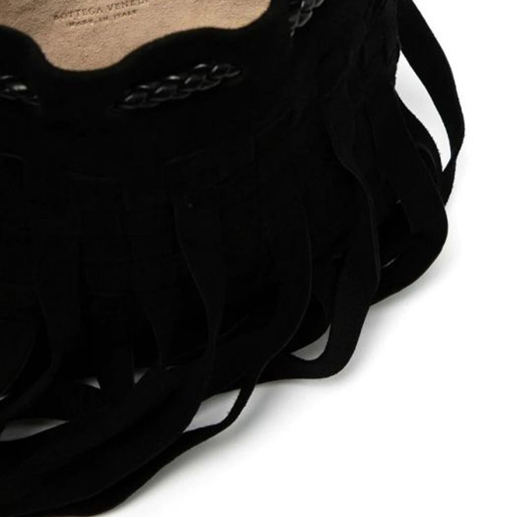 Crafted from black suede leather, this pre-owned Bottega Veneta fringed mini bag has been designed using the Maison's classic Intrecciato weaving technique. Accented with a long fringe, the bag has been designed with a single braided top handle and