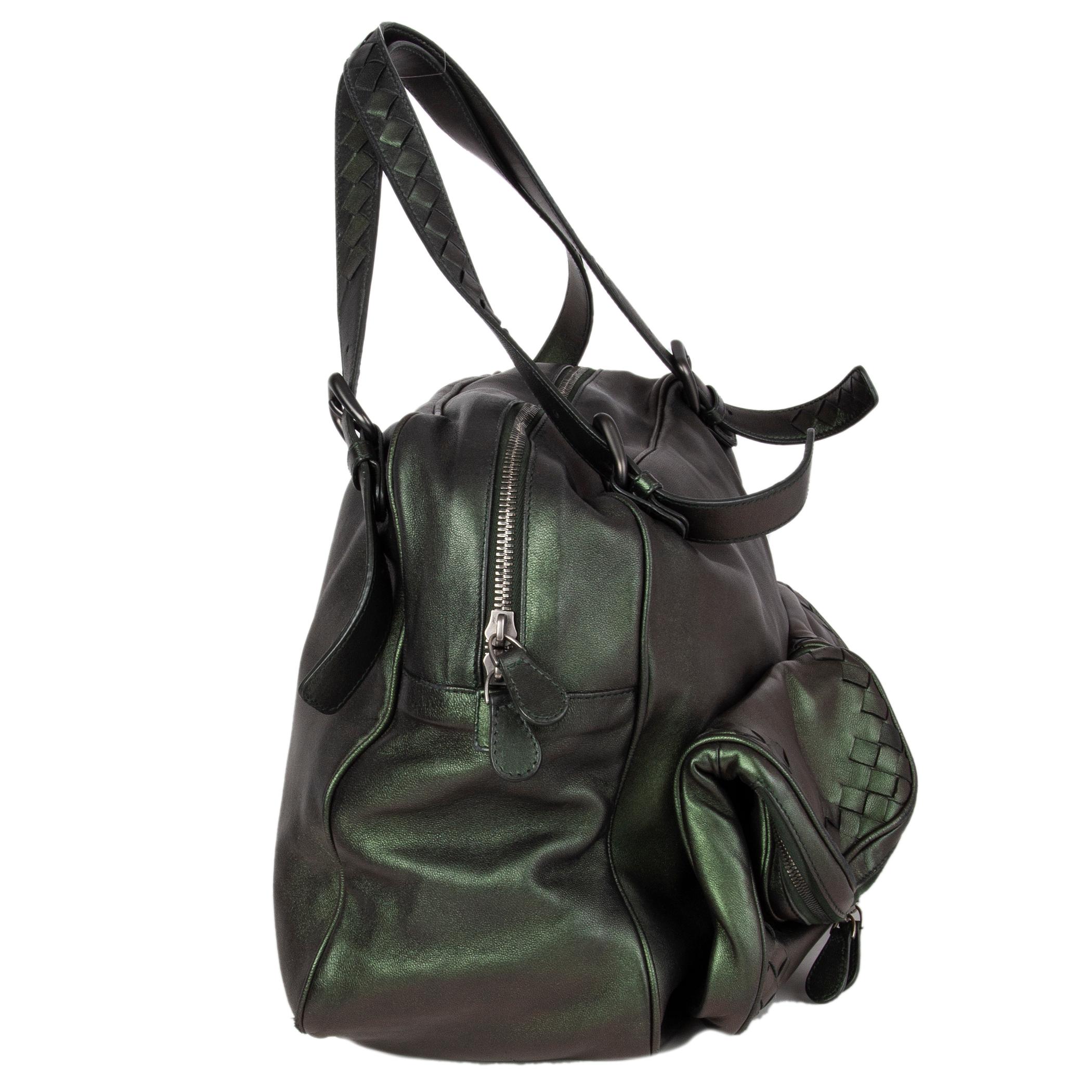 Bottega Veneta two pockets shoulder bag in Scarabee (iridescent green) leather with dual flat shoulder straps and two exterior zip pockets with Intrecciato leather trim. Opens with a zipper on top. Lined in taupe suede with two open pockets against