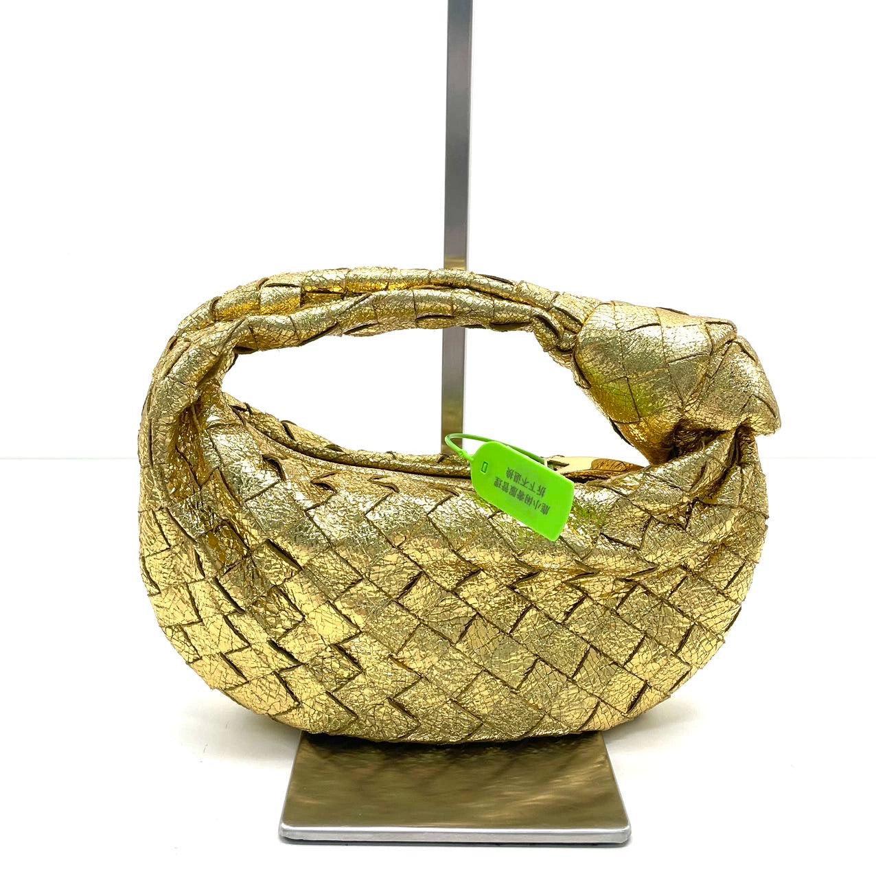 Bottega Veneta Jodie Mini Gold Leather Rare
These are professional photos of the actual bag.
  The Bottega Veneta Jodie Mini in super rare gold Leather offers the perfect balance between practicality and luxury. Its mini size serves as a great